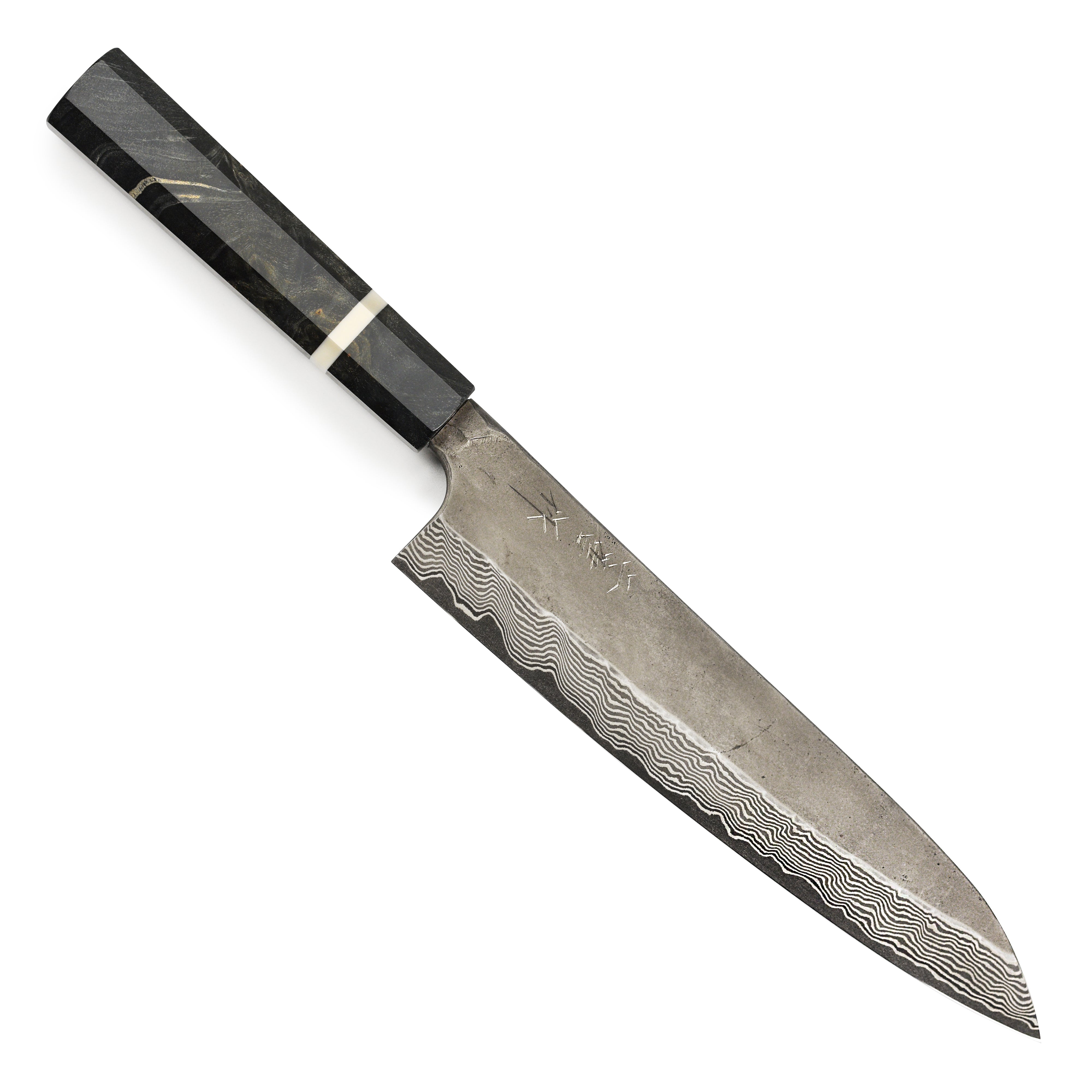 Japanese chef knife in action, slicing vegetables with the Nigara Ginsan Ginsan Kurozome Damascus steel blade