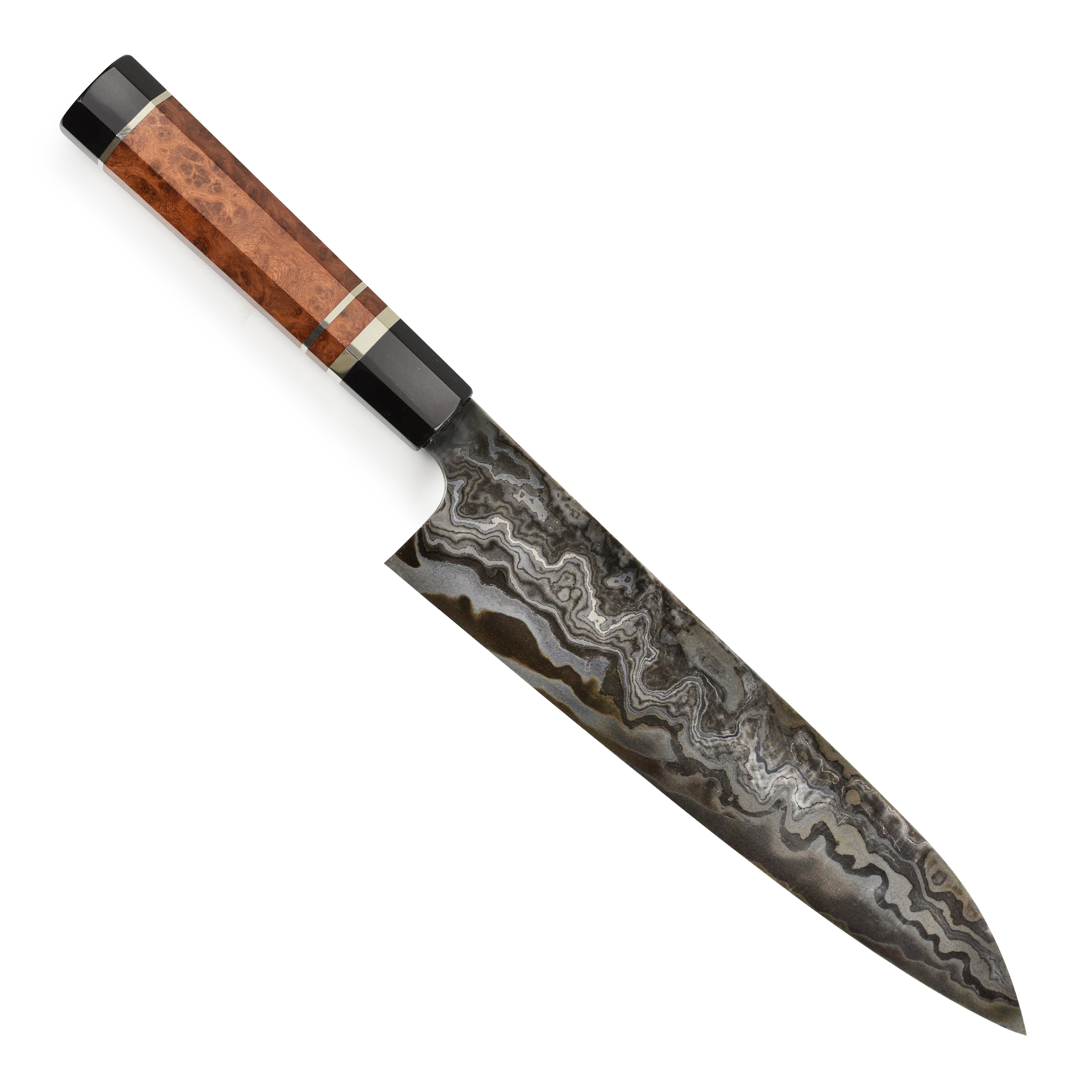 Close-up of the Nigara Kagetora Damascus knife showing intricate steel layering and polished edge