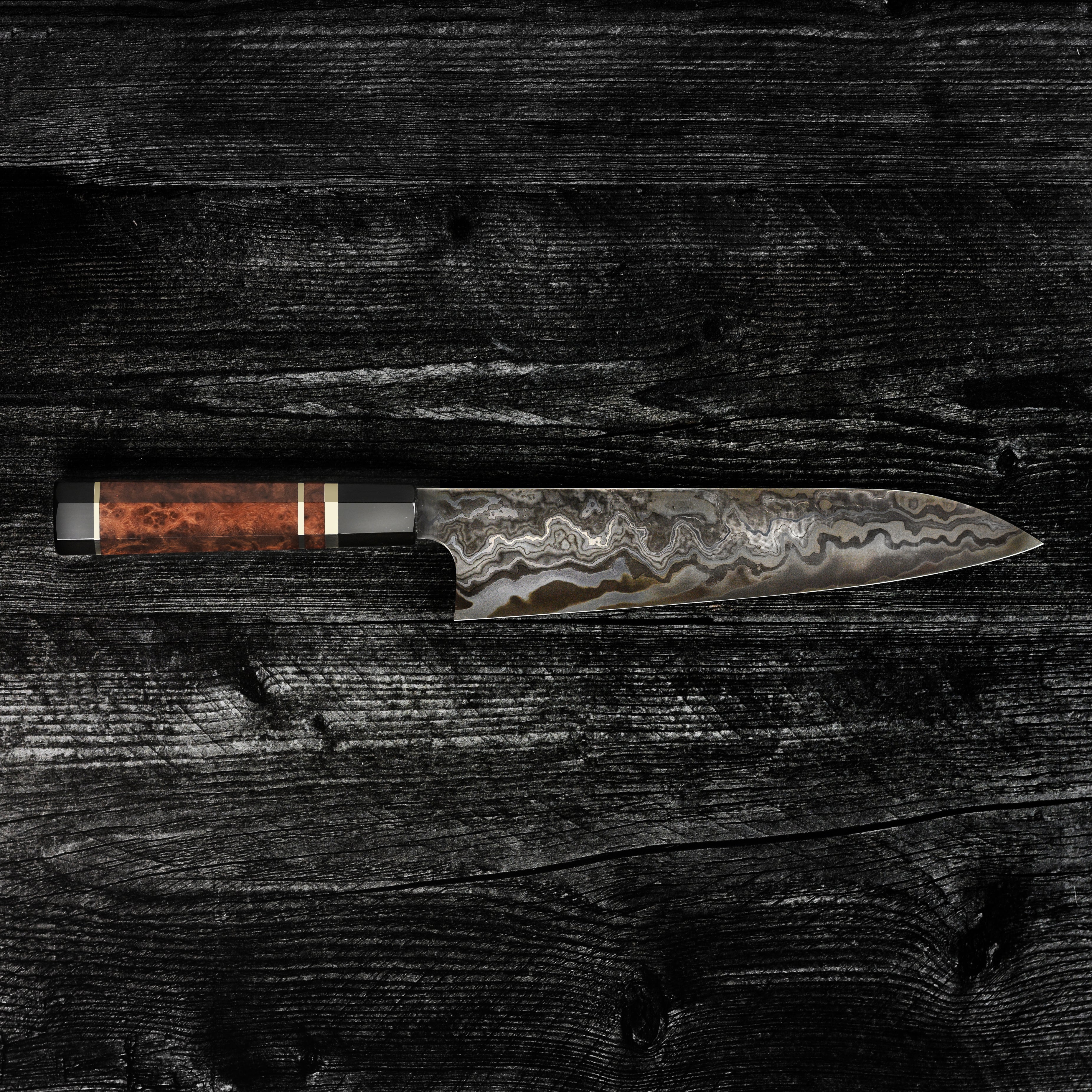 Close-up of the Nigara Kagetora Damascus knife showing intricate steel layering and polished edge