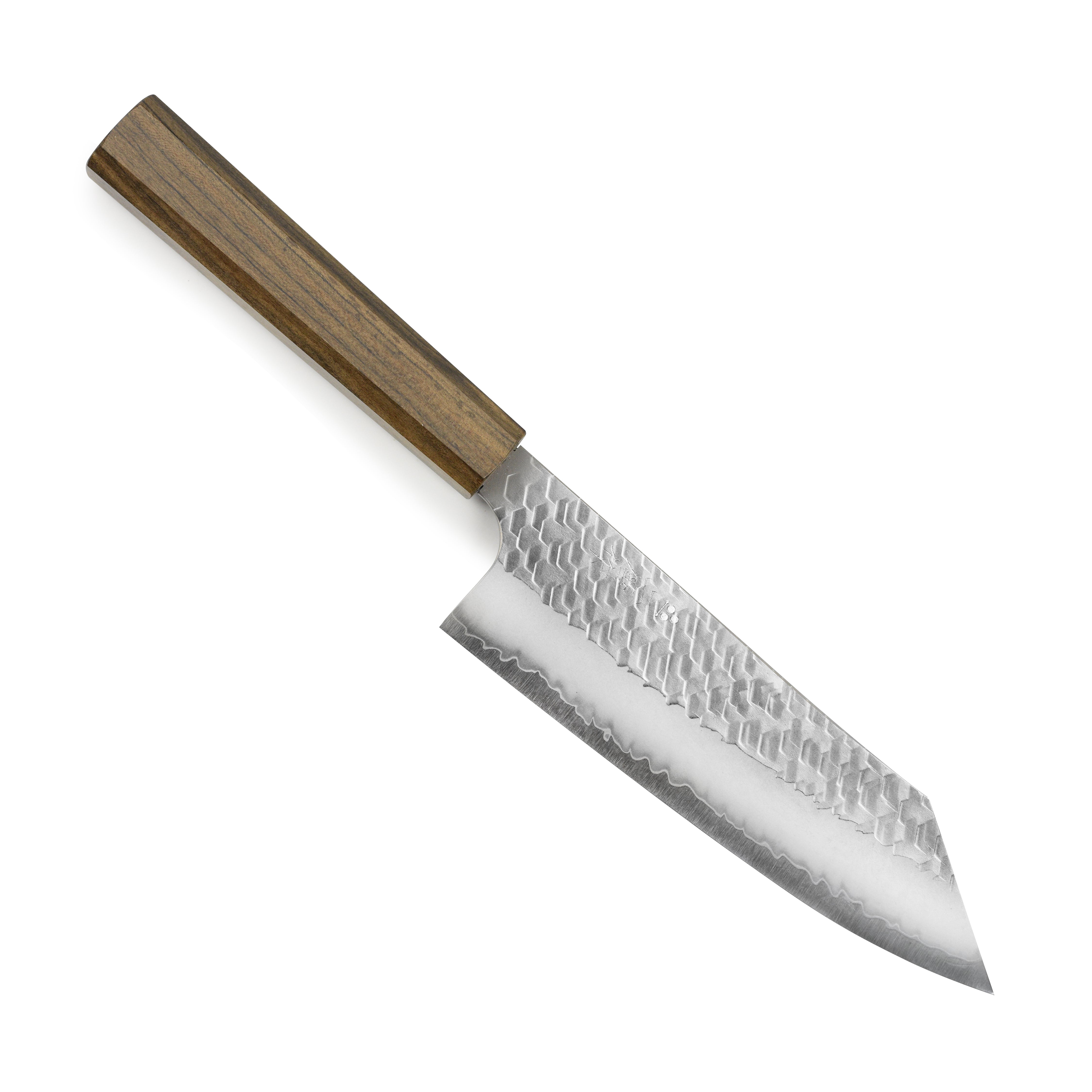 Chef using the Nigara SG2 bunka knife to slice vegetables on a wooden cutting board.