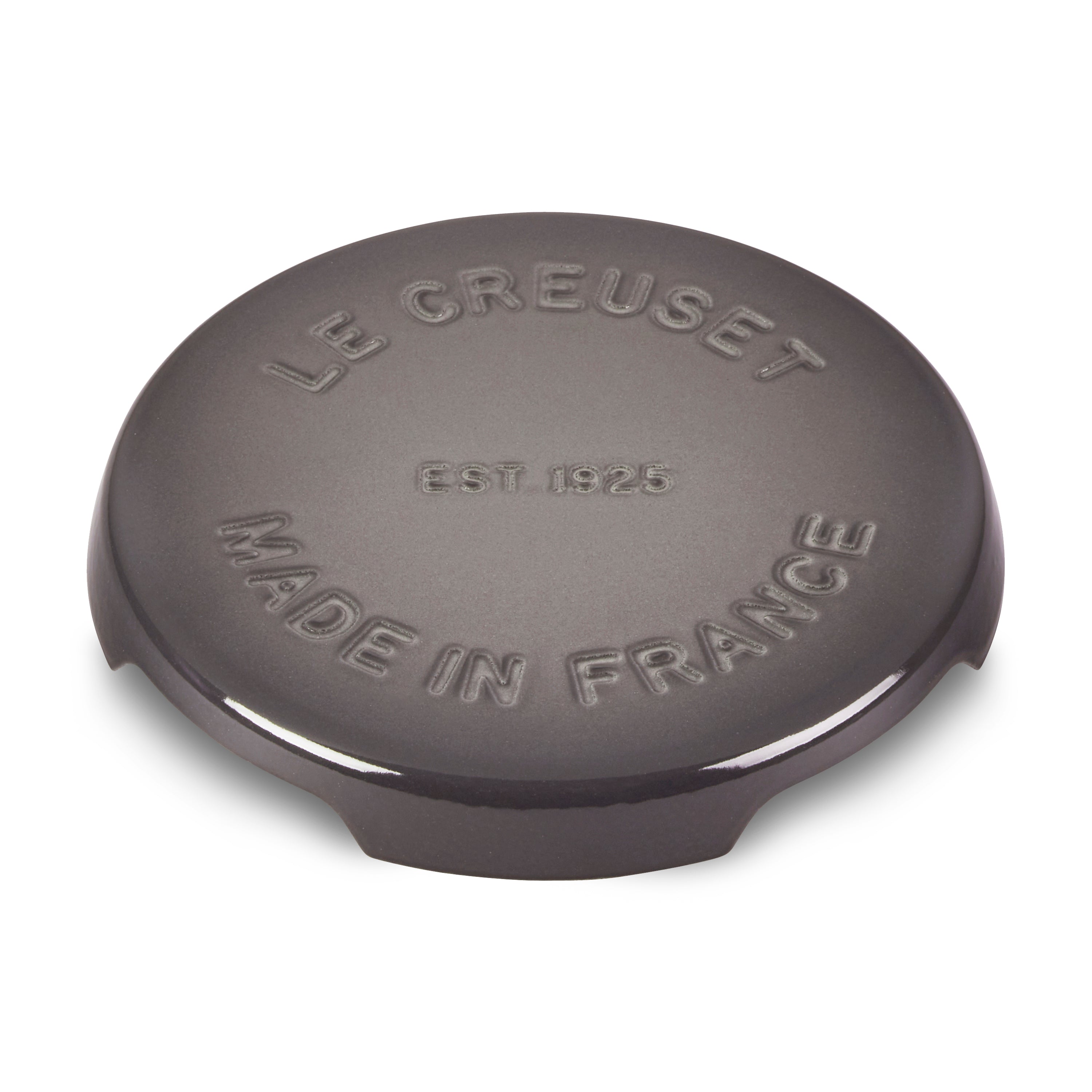 Le Creuset cast iron trivet in oyster color, perfect for hot dishes.