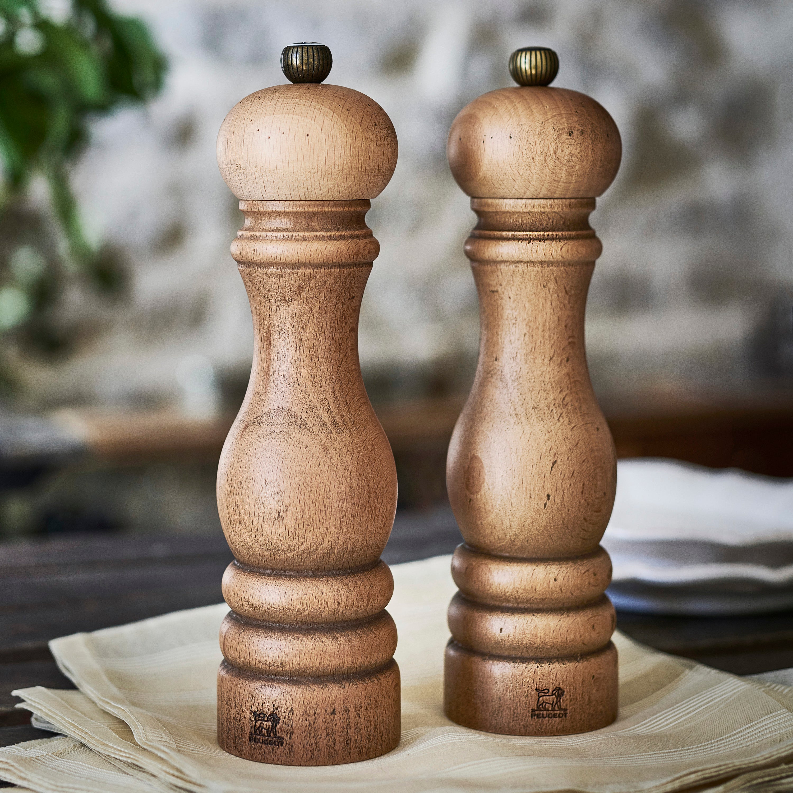 Elegant Peugeot Paris Salt and Pepper Mill Set showcasing its brass top and wooden finish.