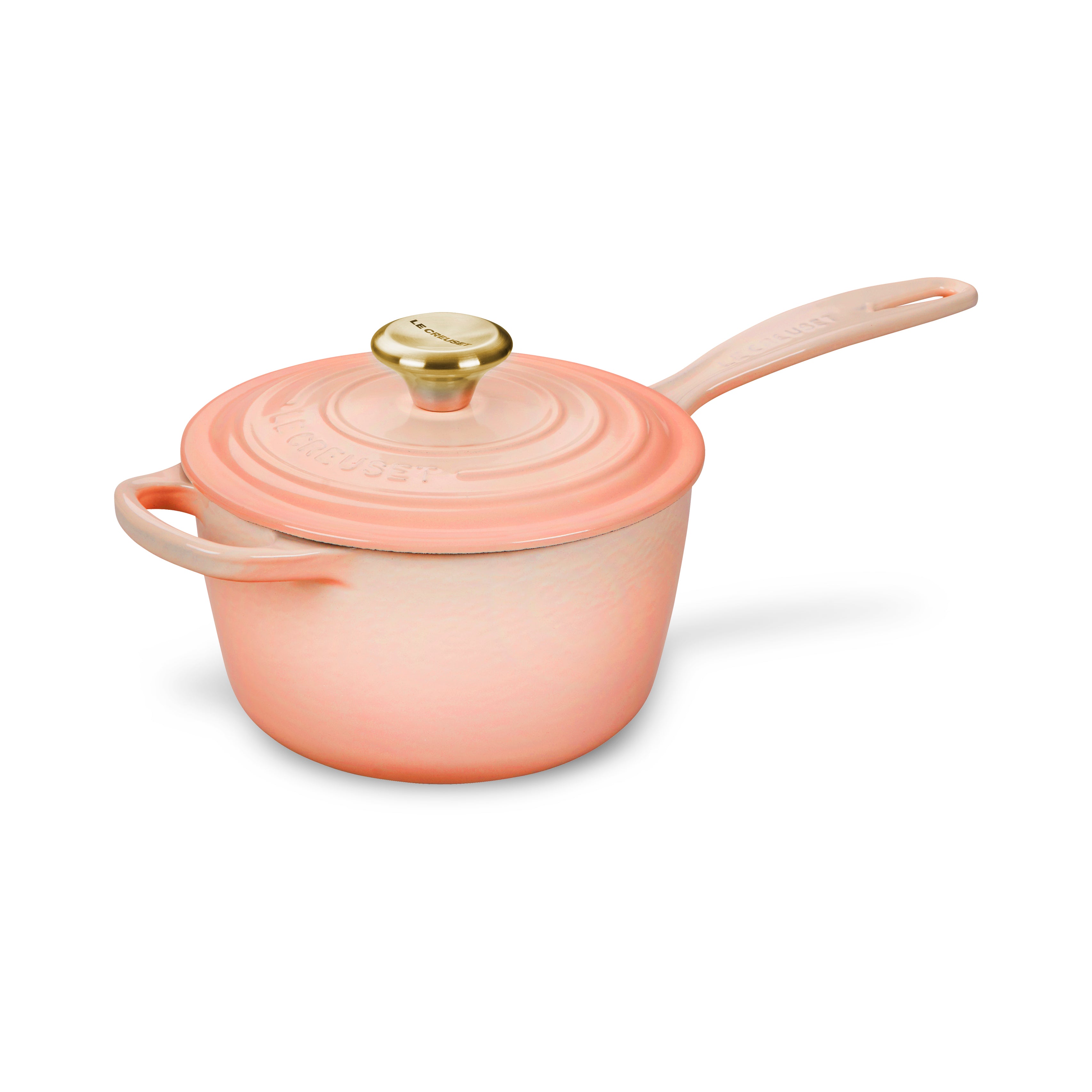 Close-up of Le Creuset enameled cast iron saucepan with lid, showcasing its durable finish.