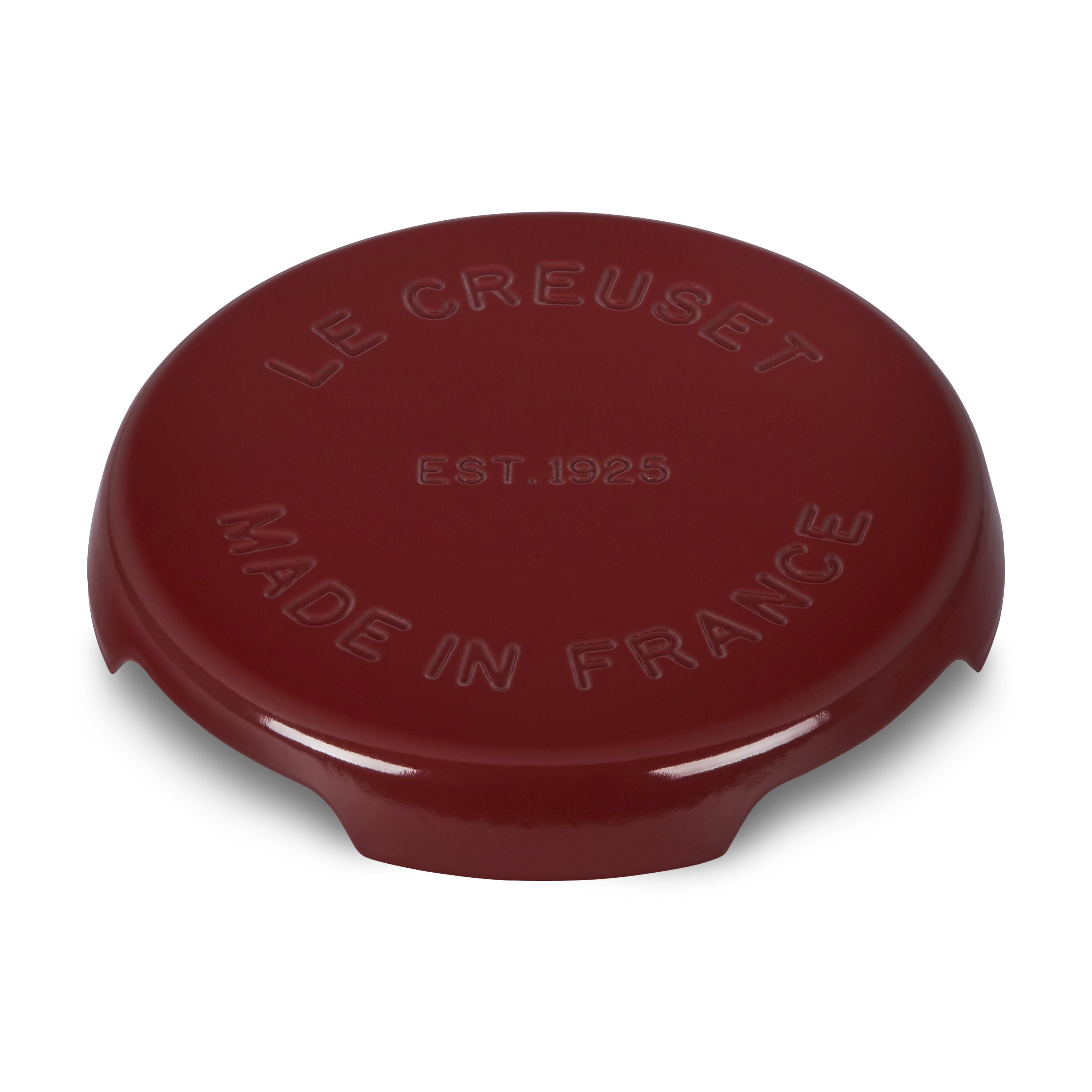Close-up of the Le Creuset cast iron trivet in Rhone red on a kitchen countertop