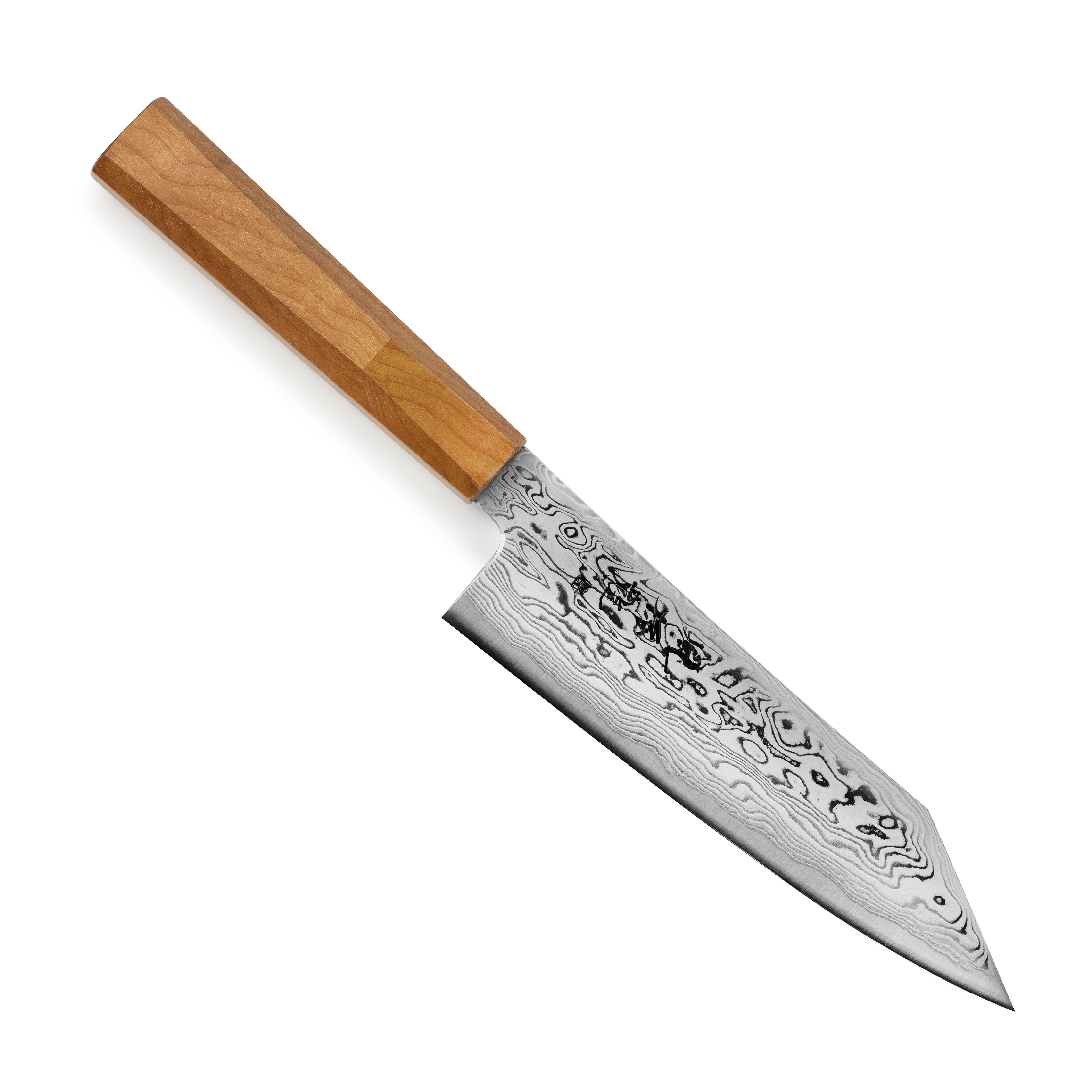 Professional chef using a Japanese knife to chop vegetables in a modern kitchen