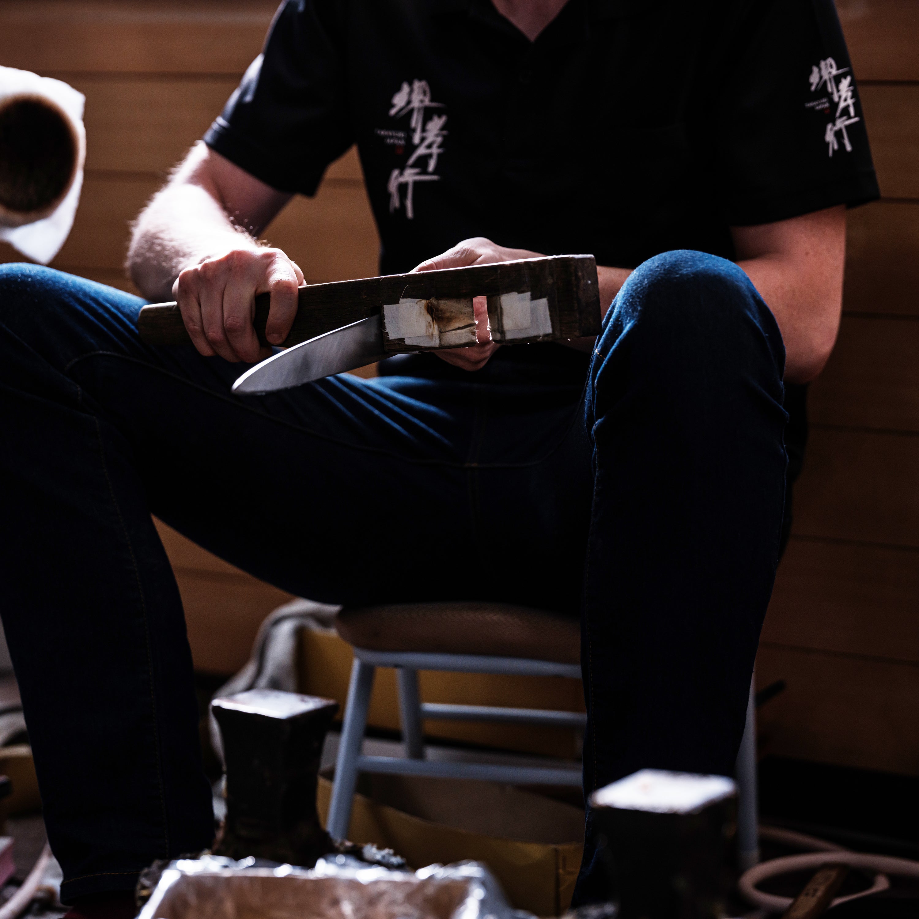 Close-up of the Sakai Ginsan hand-forged 7-inch Santoku knife highlighting the blades edge and craftsmanship.