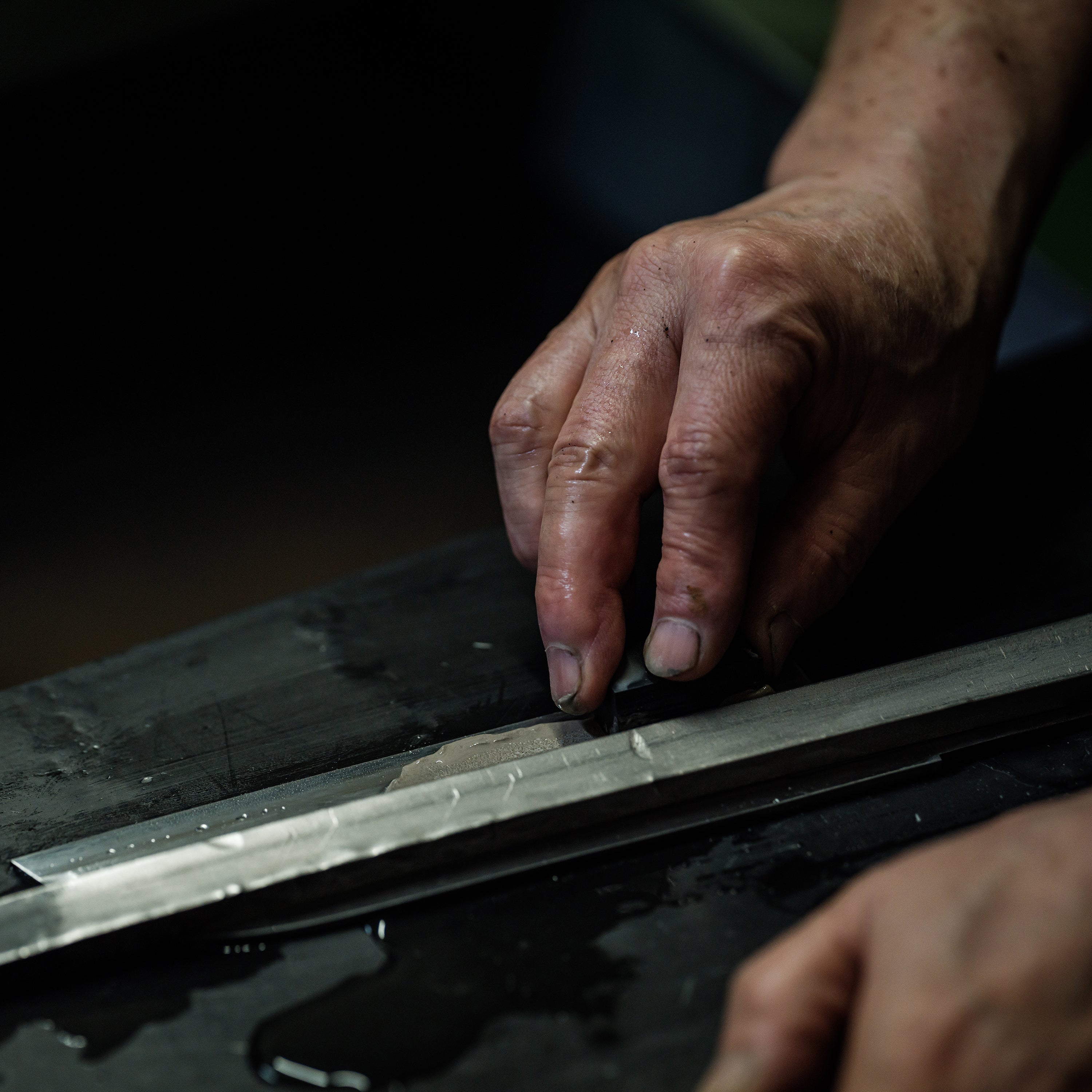 Ginga Damascus Chef Knife showcasing its beautiful mirror finish and sharp edge.