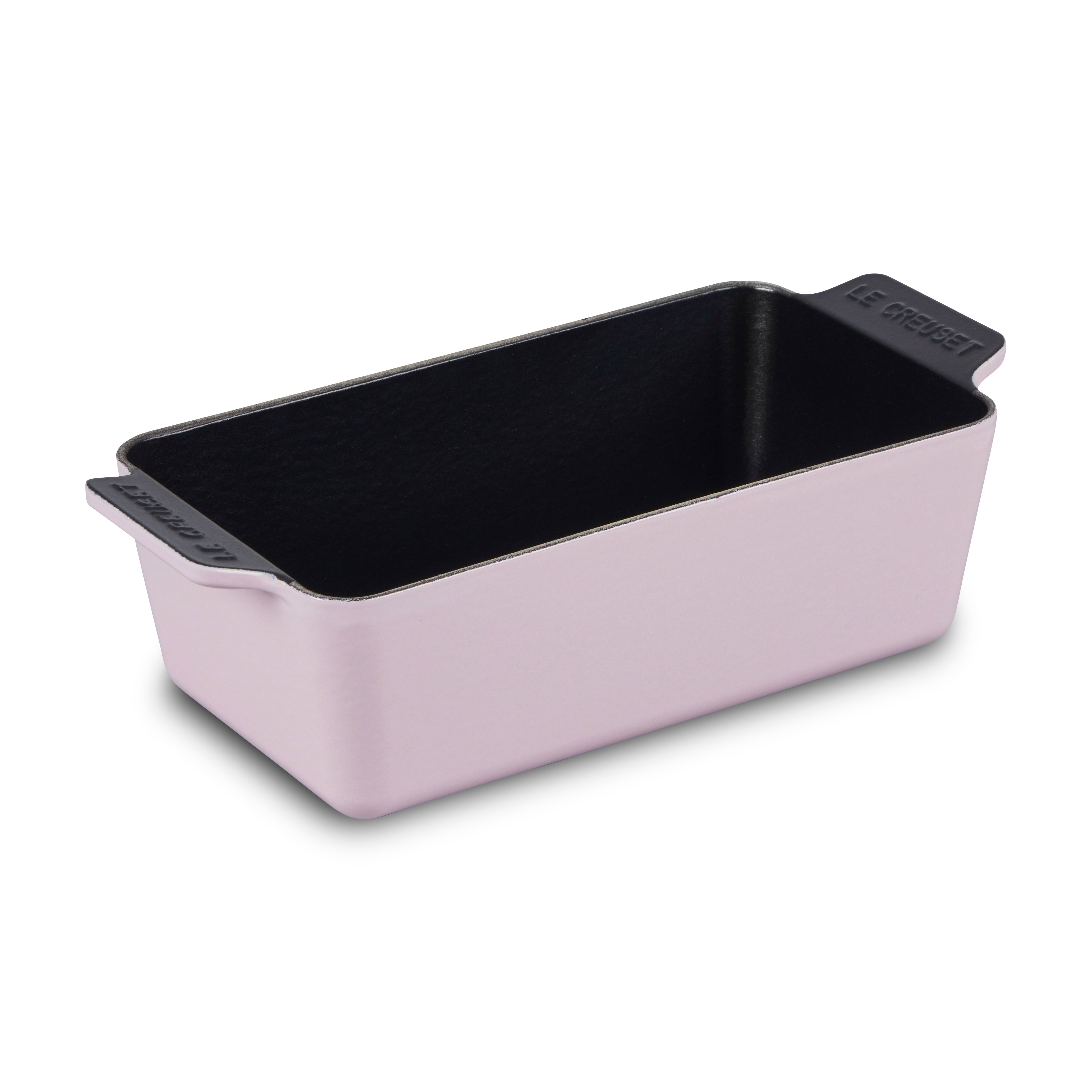 Le Creuset cast iron loaf pan with bread baking inside, showing even heat and professional finish
