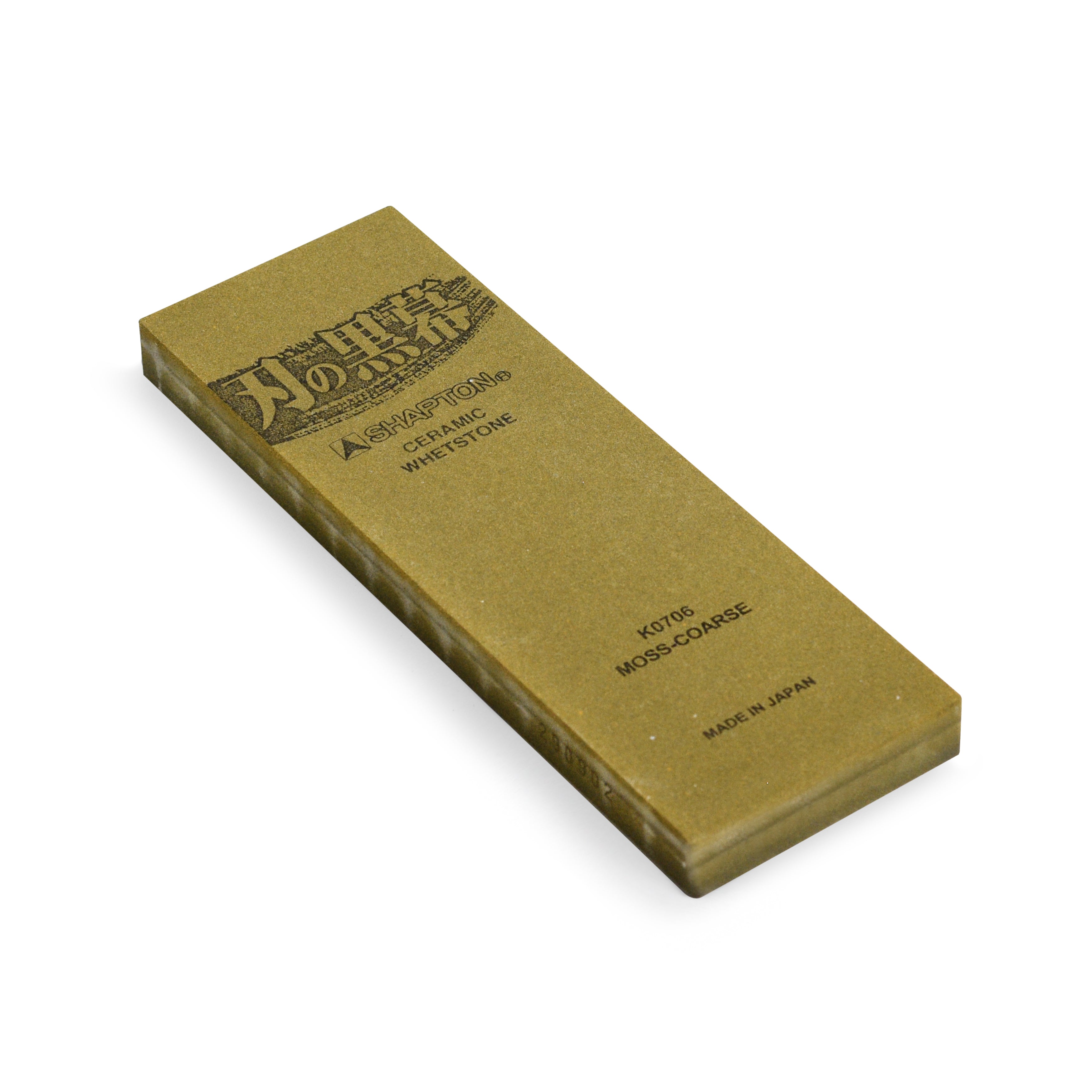 Close-up view of Shapton Kuromaku 220 grit water stone on a wooden table