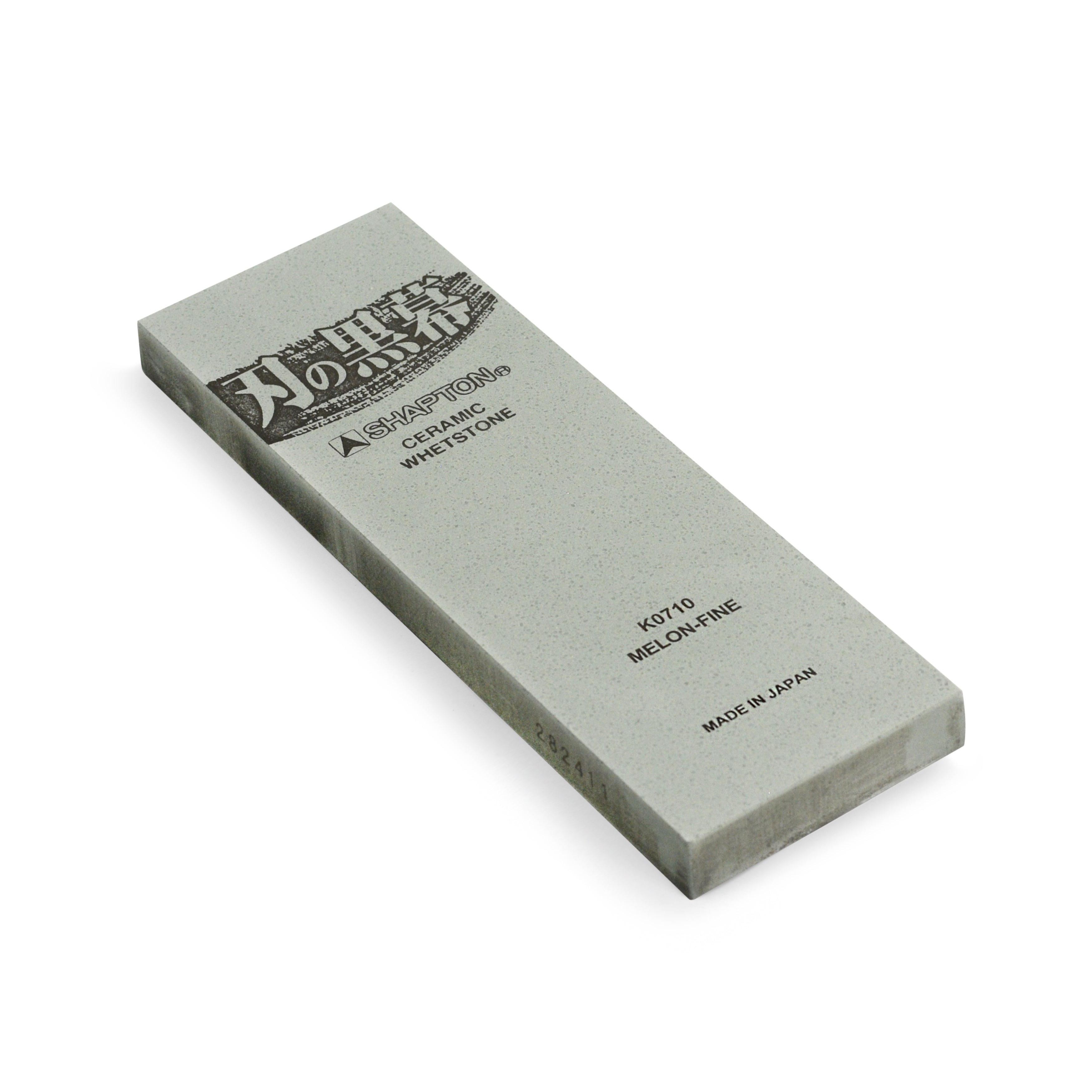 Shapton Kuromaku 8,000 grit sharpening stone with a kitchen knife, highlighting its fine finish.