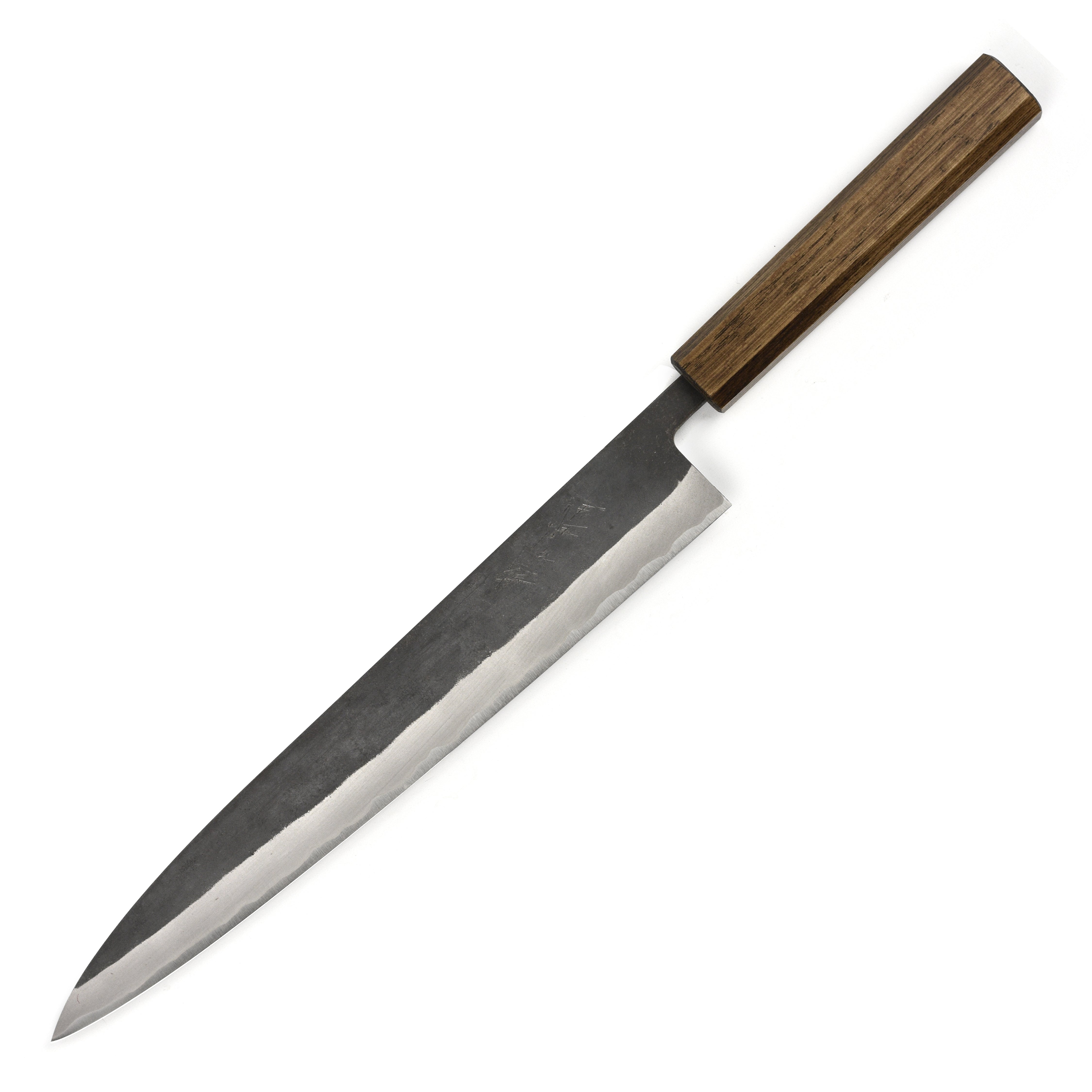 Close-up of the Shiro Kamo Aogami Sujihiki Knife on a wooden cutting board.
