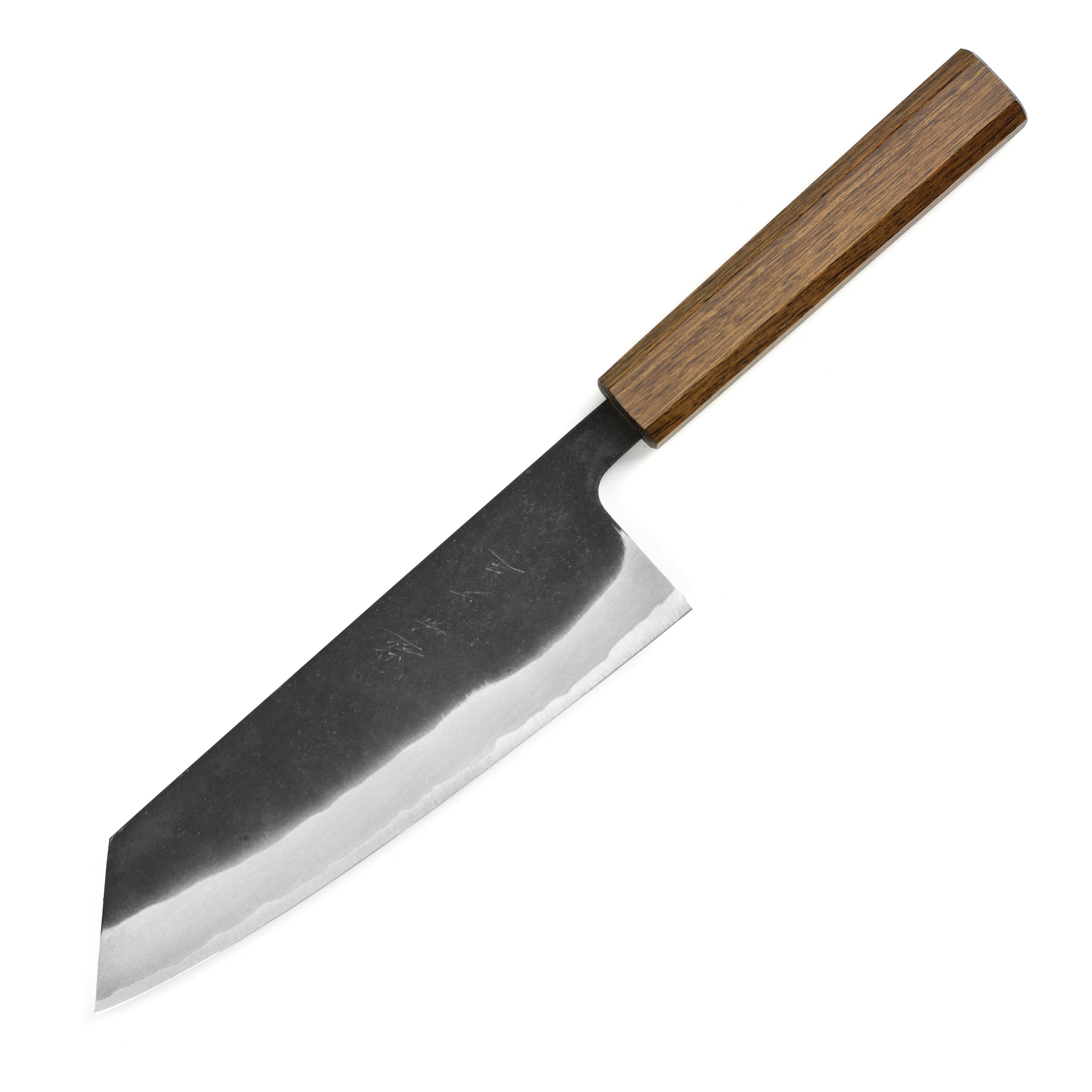 Shiro Kamo Aogami Bunka knife in action, slicing fresh vegetables on a wooden cutting board.