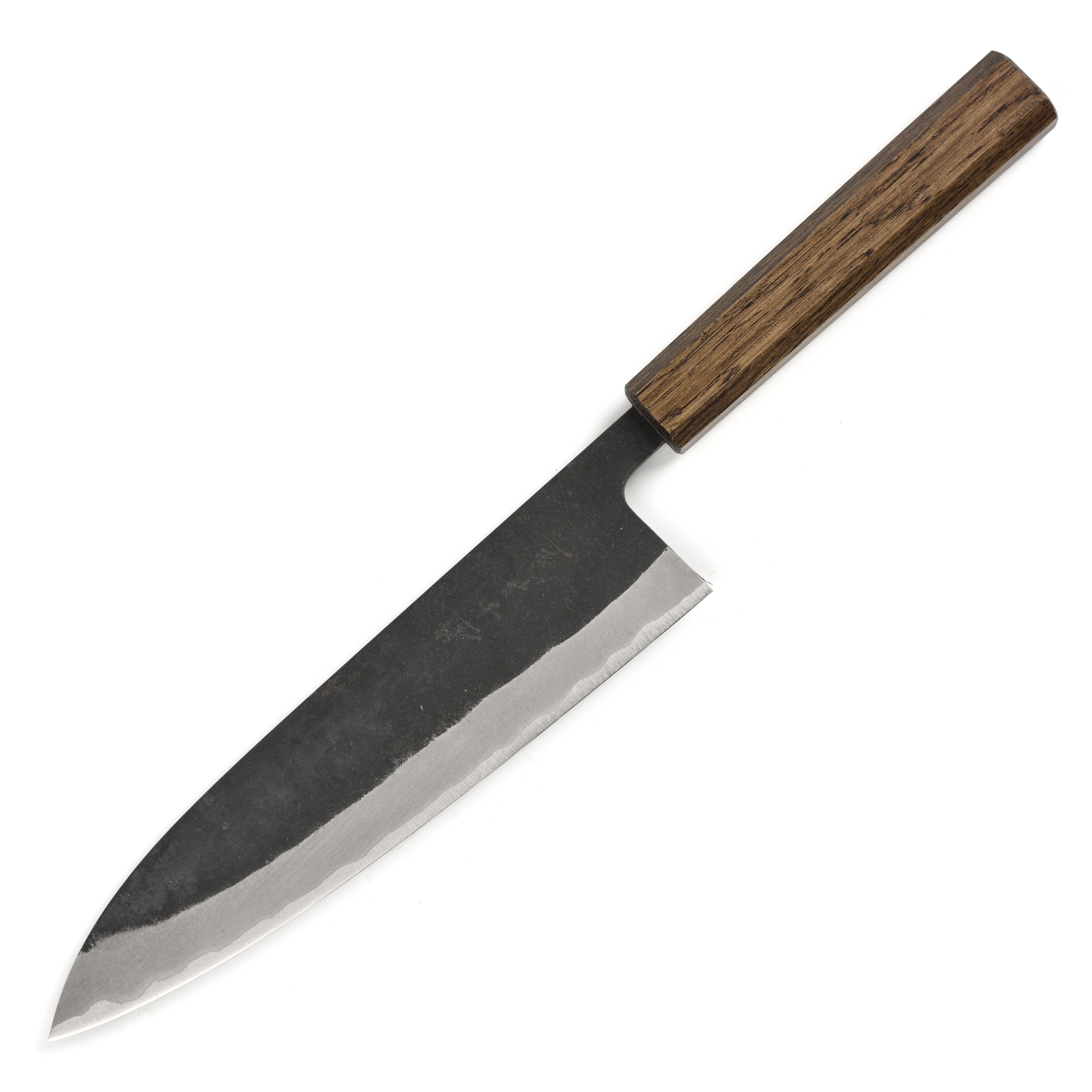 Chef slicing vegetables with the Japanese chef knife on a wooden cutting board