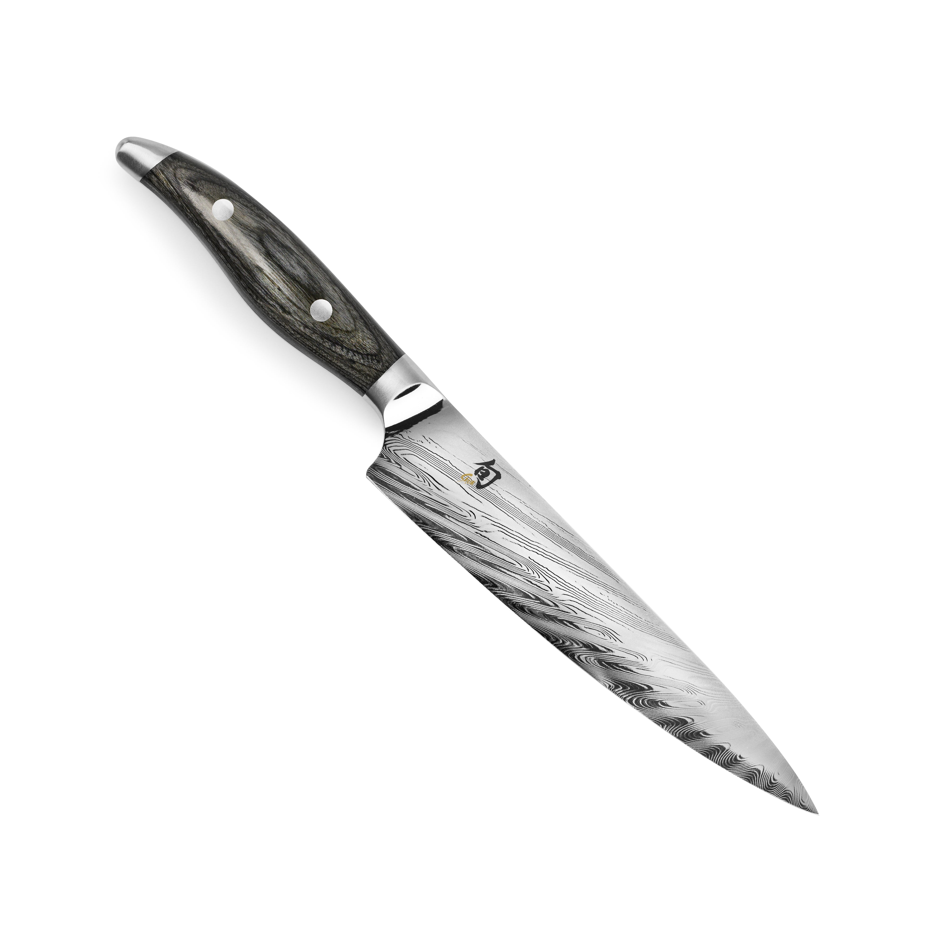 Side view of the Shun Nagare 6-Inch Utility Knife revealing the intricate Damascus pattern and sharp edge.