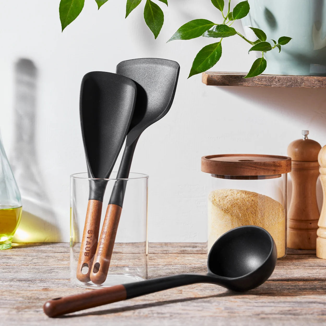 Premium silicone spatula set displayed on a kitchen counter with acacia wood handles.