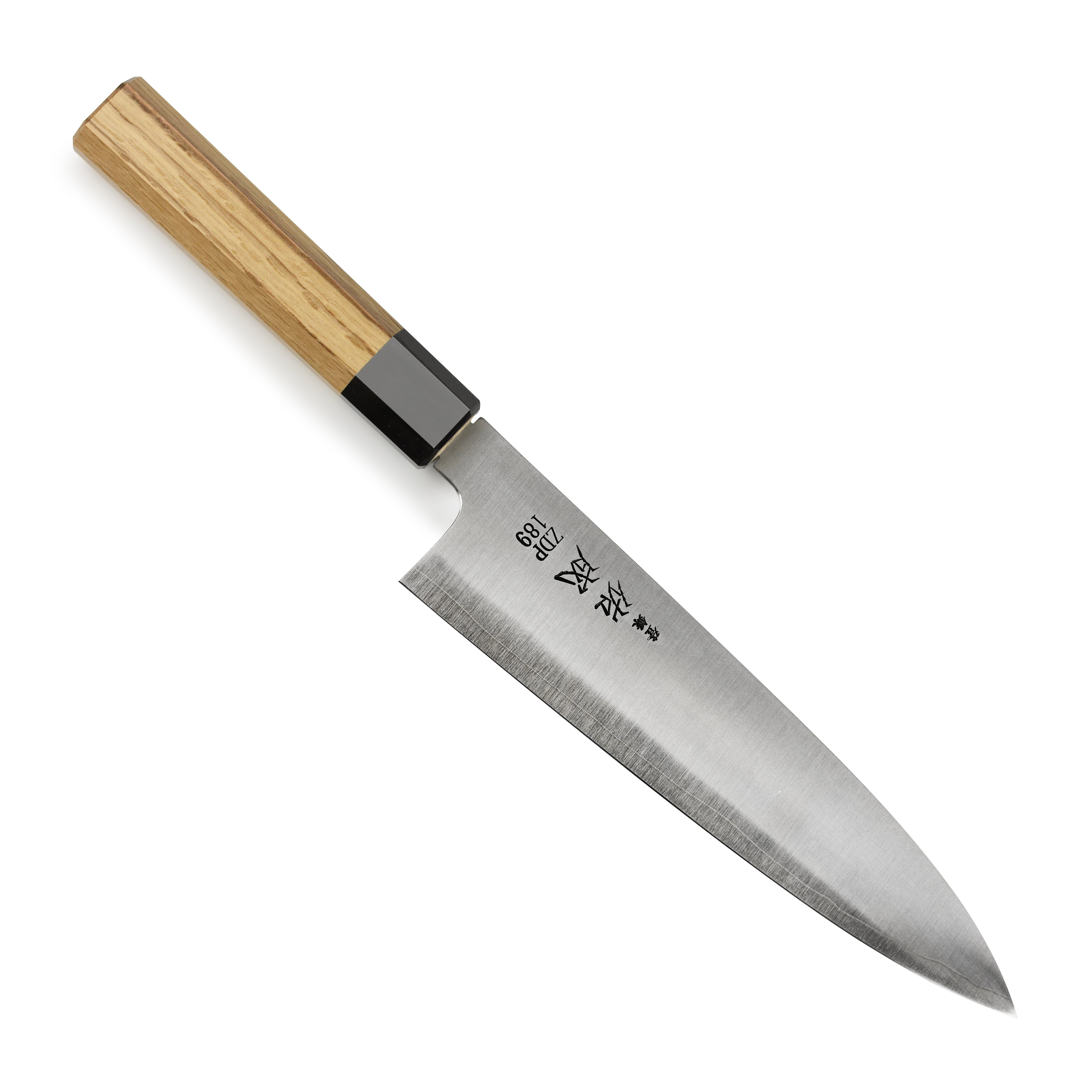 Sukenari ZDP189 Gyuto knife from a top-down angle on a wooden cutting board.