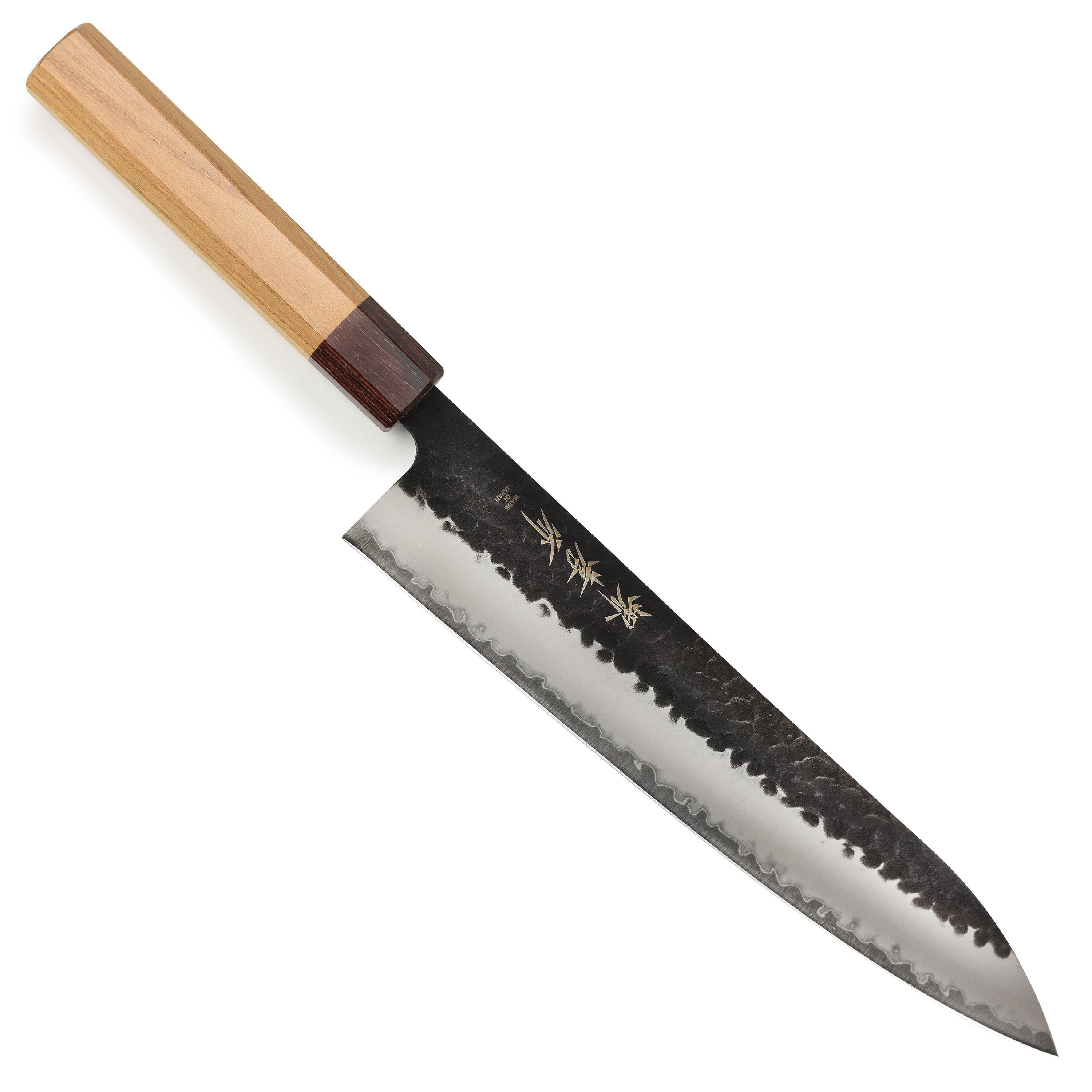 Close-up of Takayuki Aogami Super Gyuto knife showcasing the blue carbon steel blade and hammered finish.