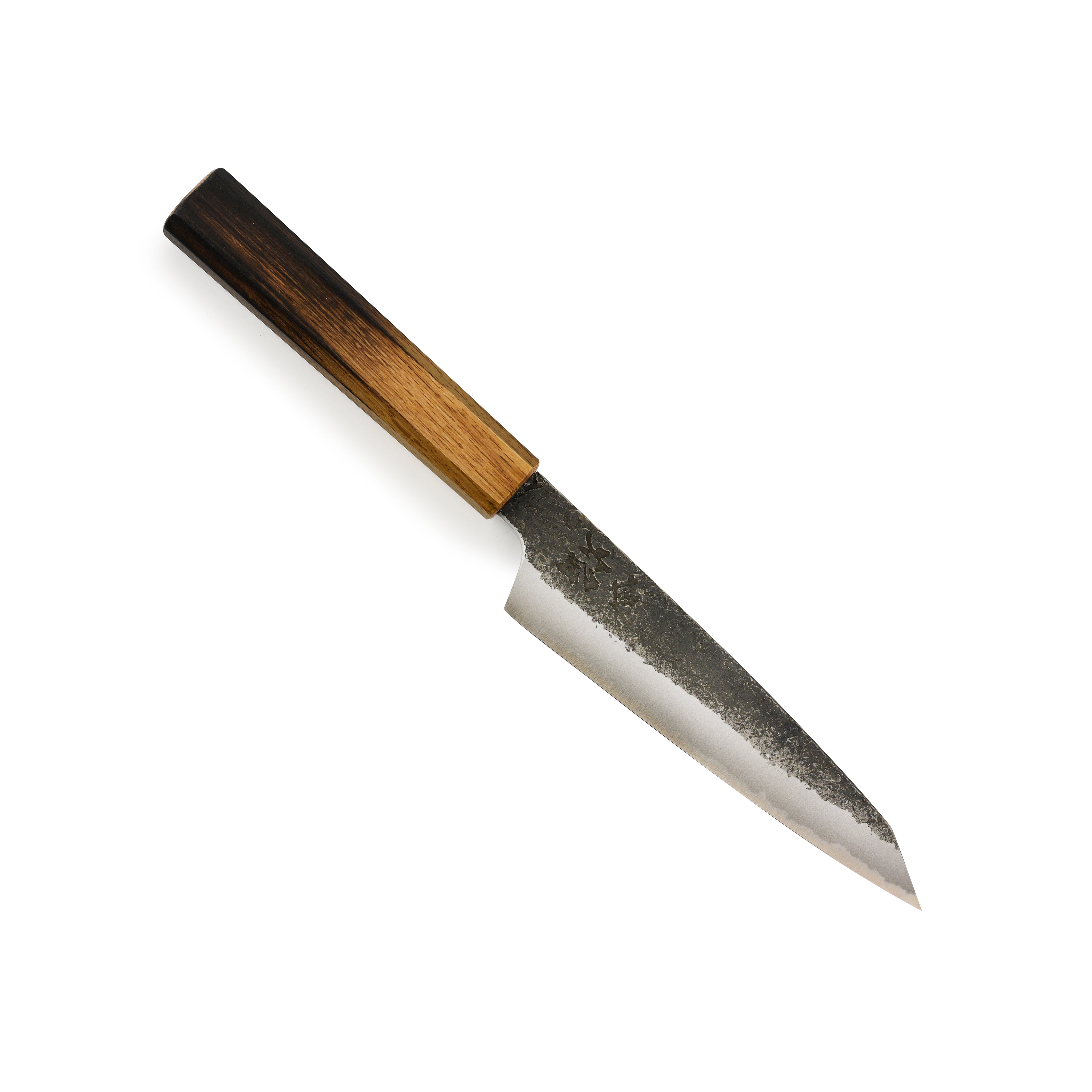 Close-up of the hand-forged Japanese chef knife with a rustic hammered finish.
