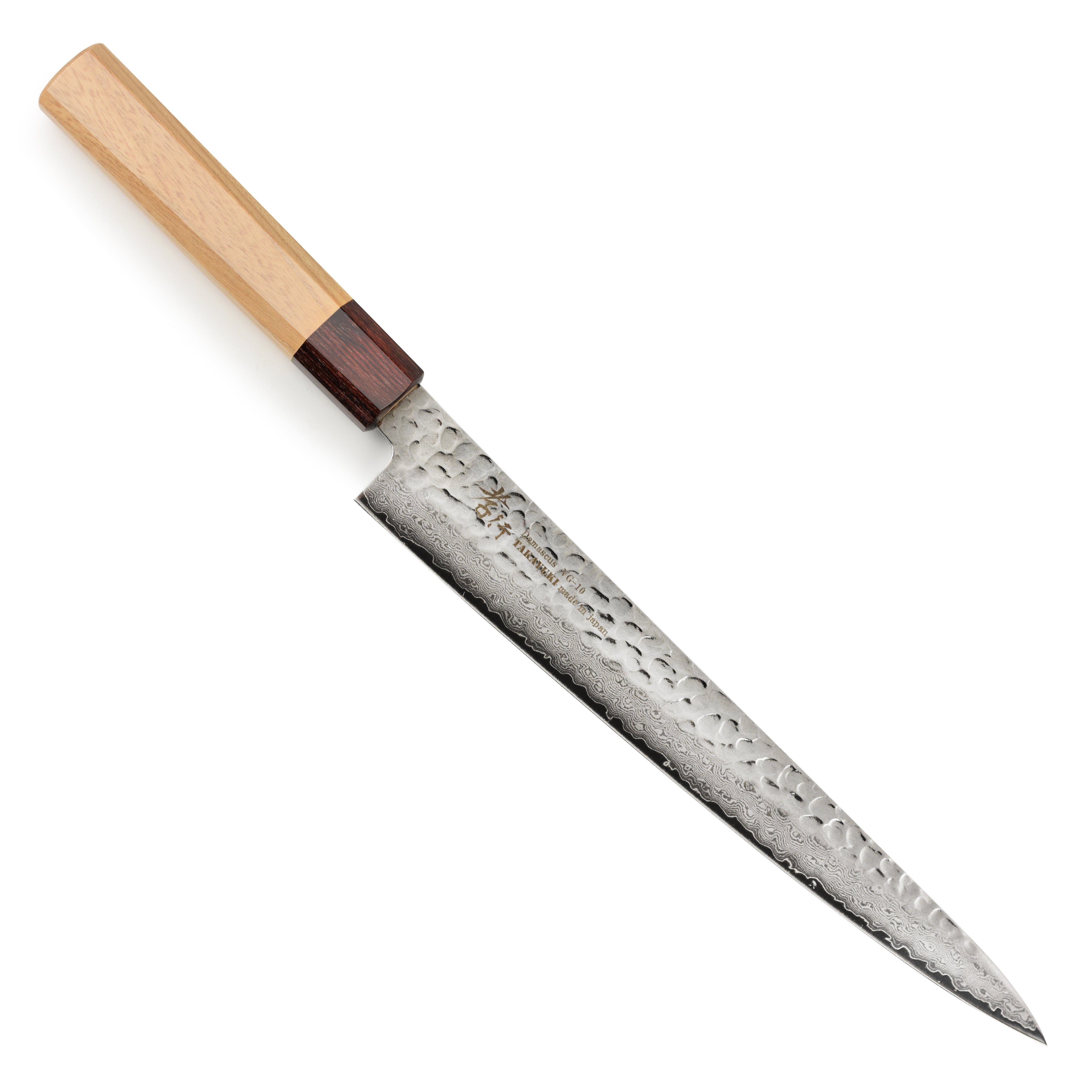 A detailed view of the Takayuki Tsuchime Damascus knife blade showcasing its layered pattern.