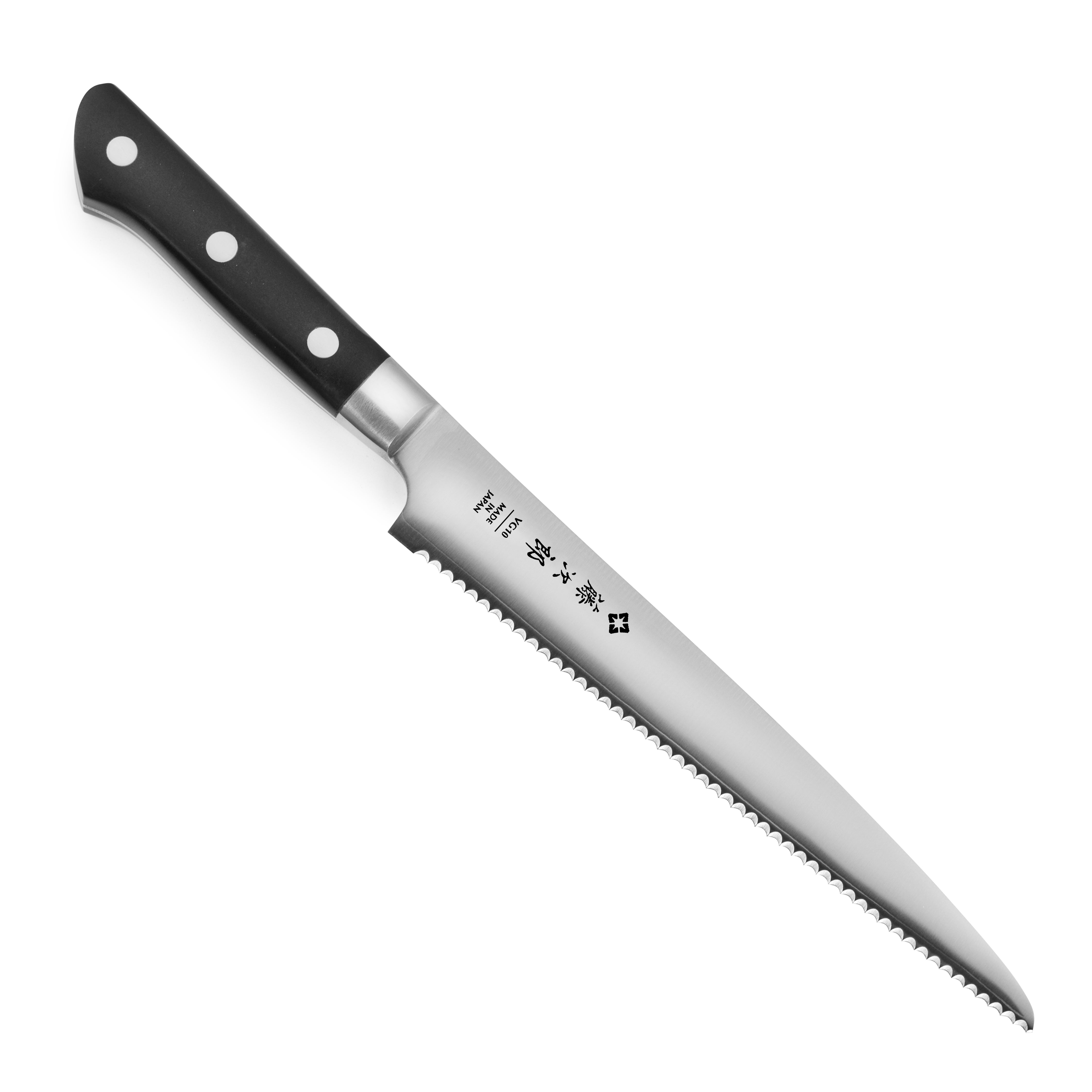 Close-up of Tojiro serrated knife slicing a rustic loaf, showcasing the VG10 steel blade