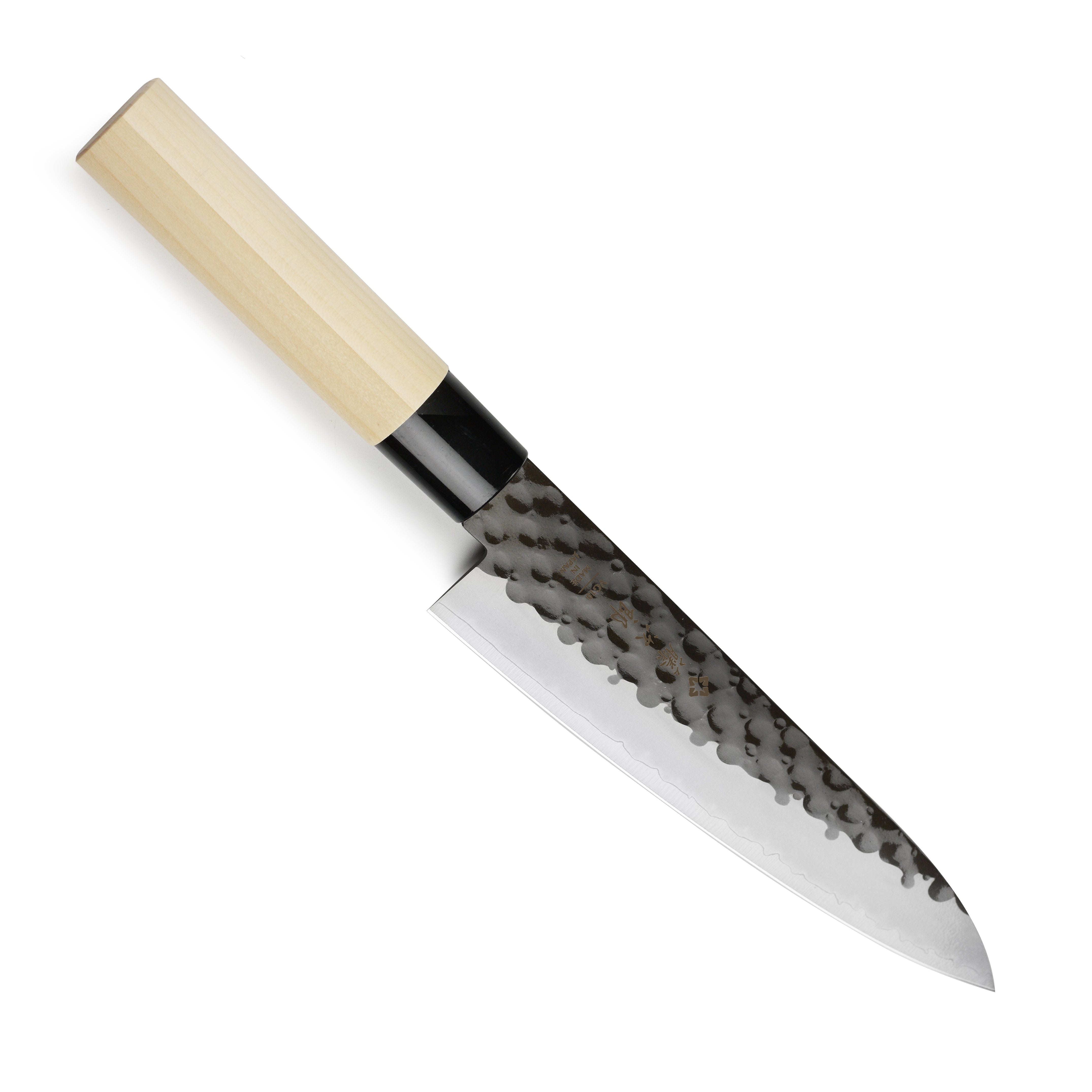 Tojiro Elite Hammered Gyuto knife in use, expertly slicing vegetables on a kitchen countertop.