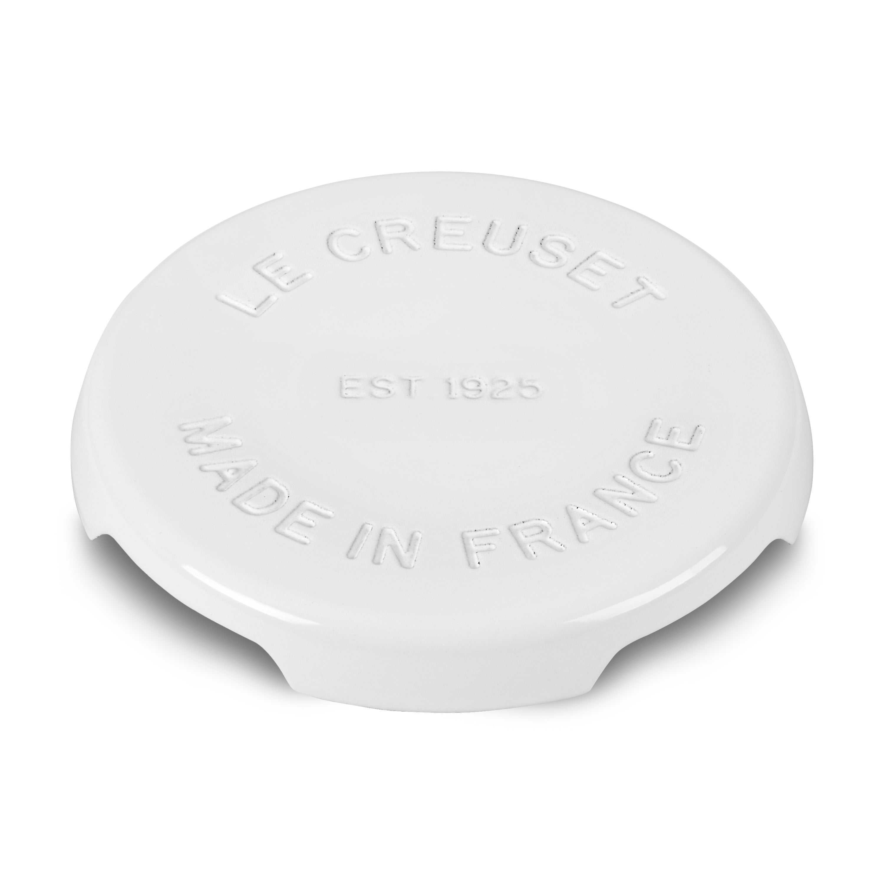 Le Creuset cast iron trivet elevating hot dishes on a kitchen counter