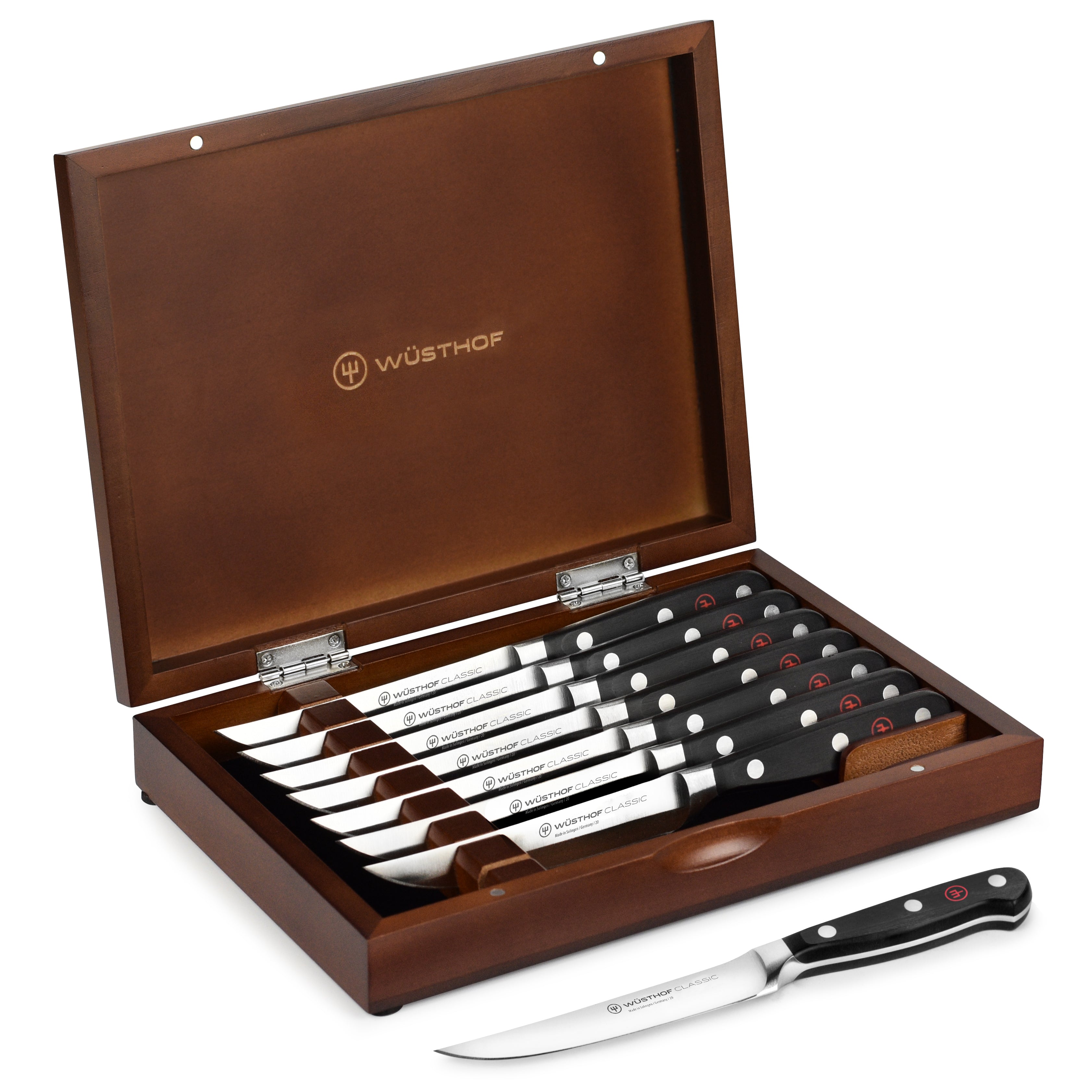 Close-up view of Wusthof premium steak knives with polished blades and elegant wood case.