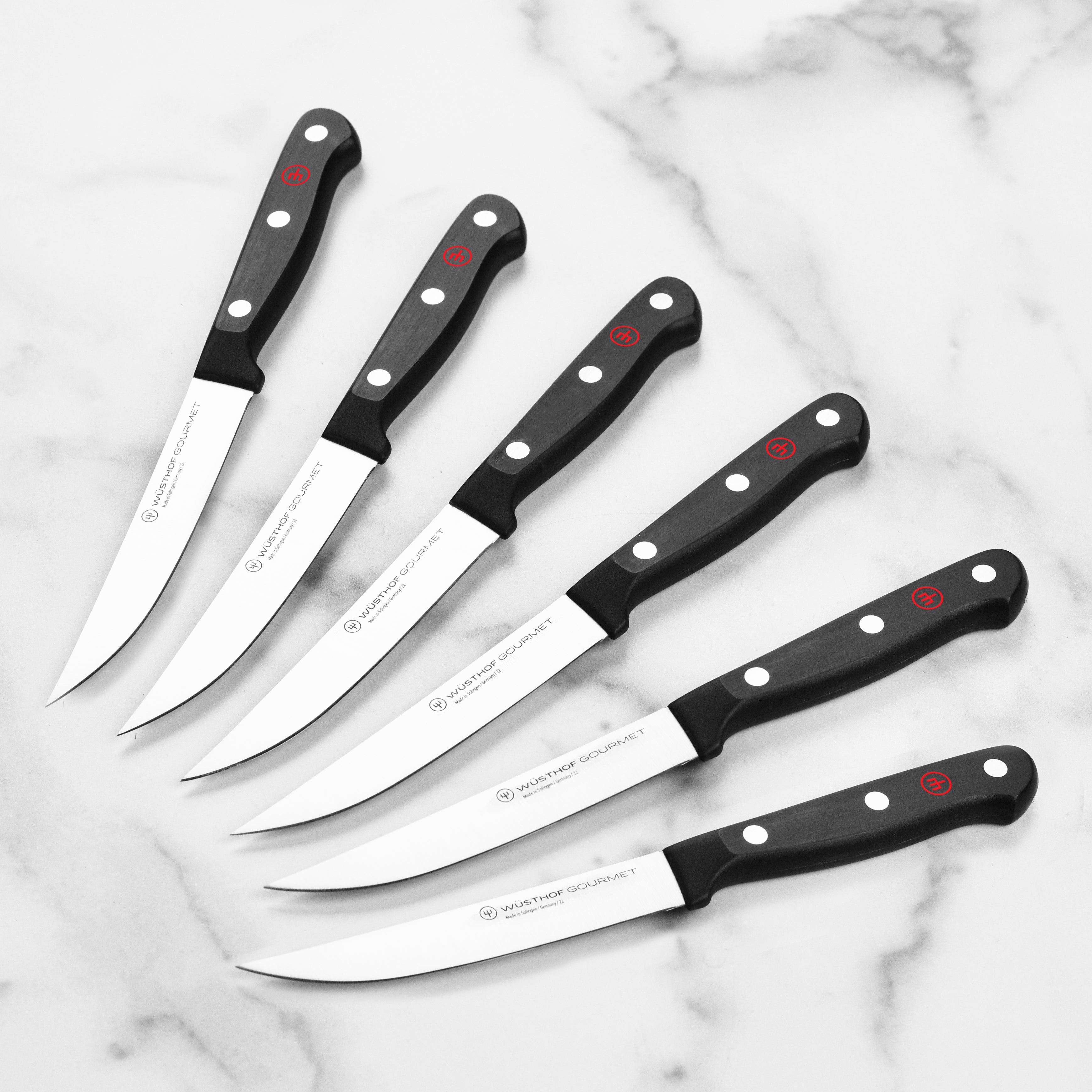 Wusthof Gourmet steak knives with high-carbon steel blades and elegant handles for precise cutting