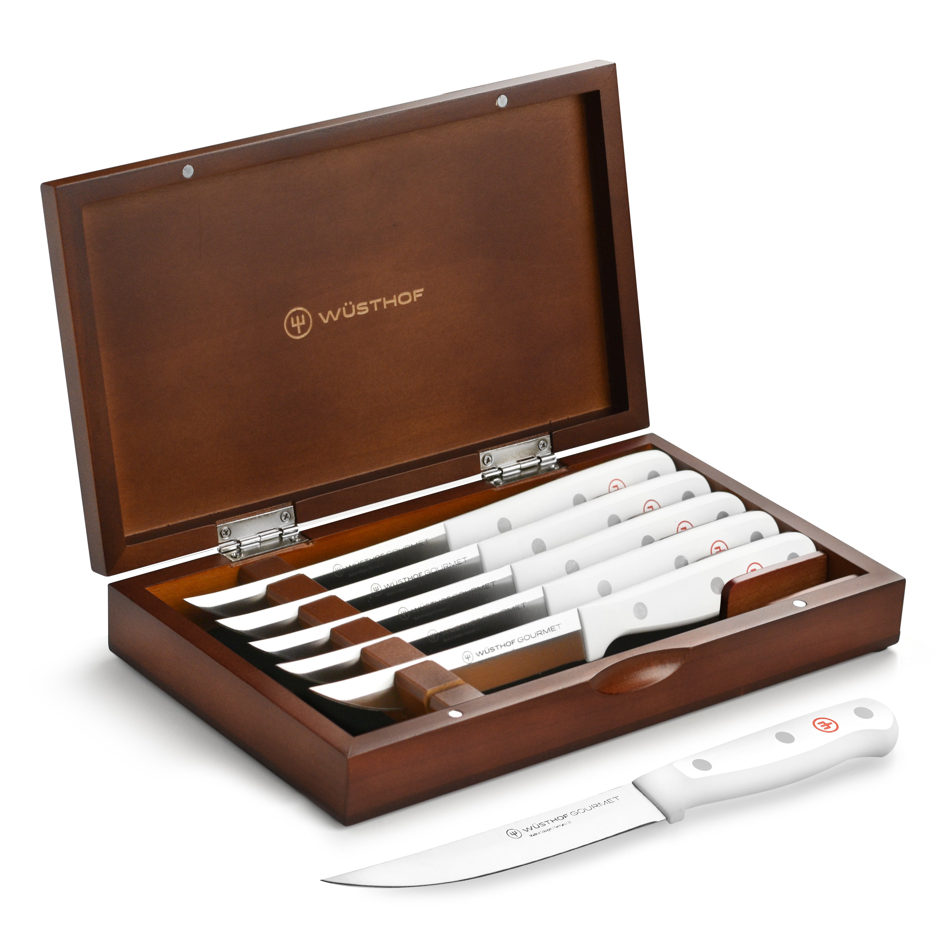 Set of Wusthof gourmet steak knives with case on a dining table