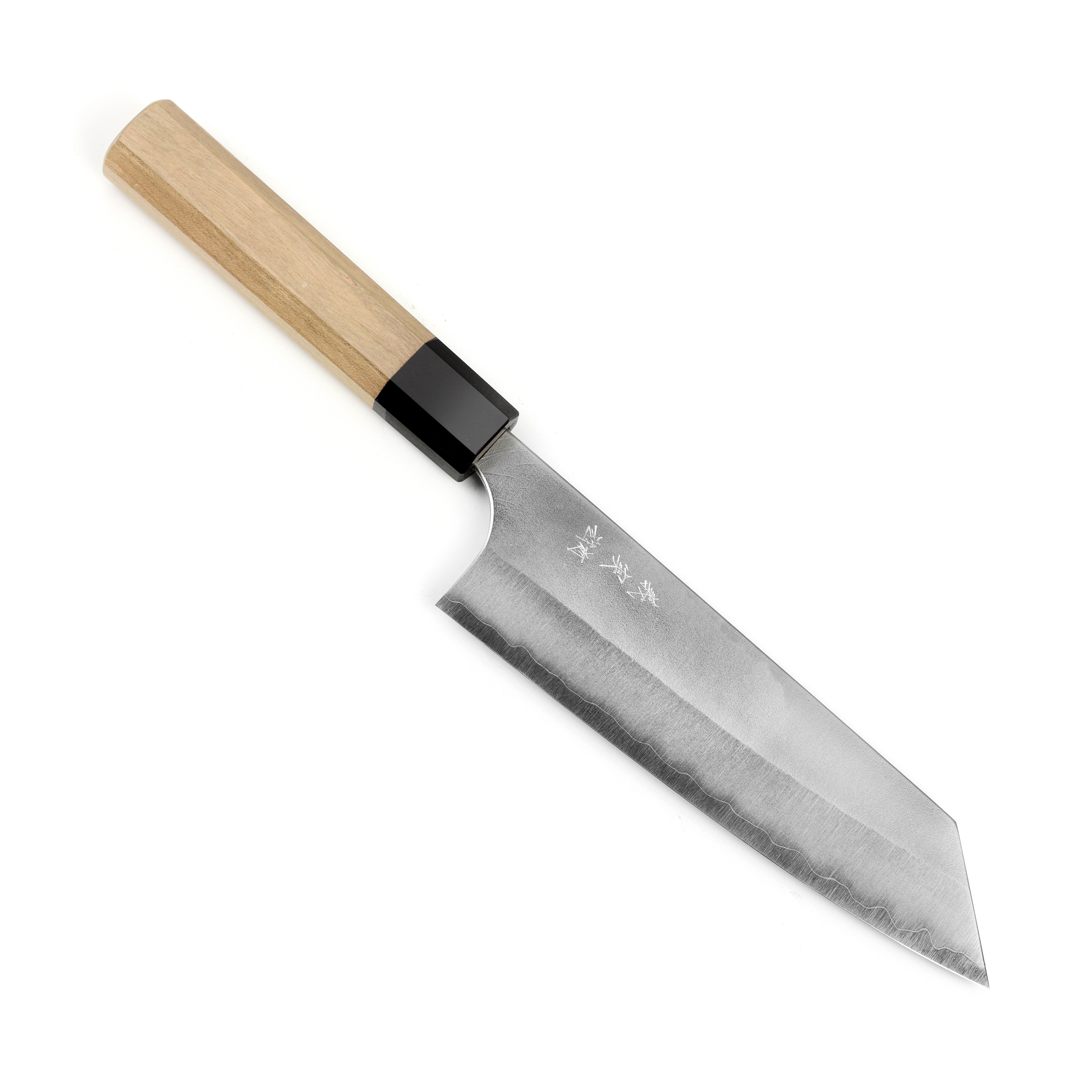 Aogami Super Nashiji Bunka knife being used to chop vegetables on a wooden cutting board.