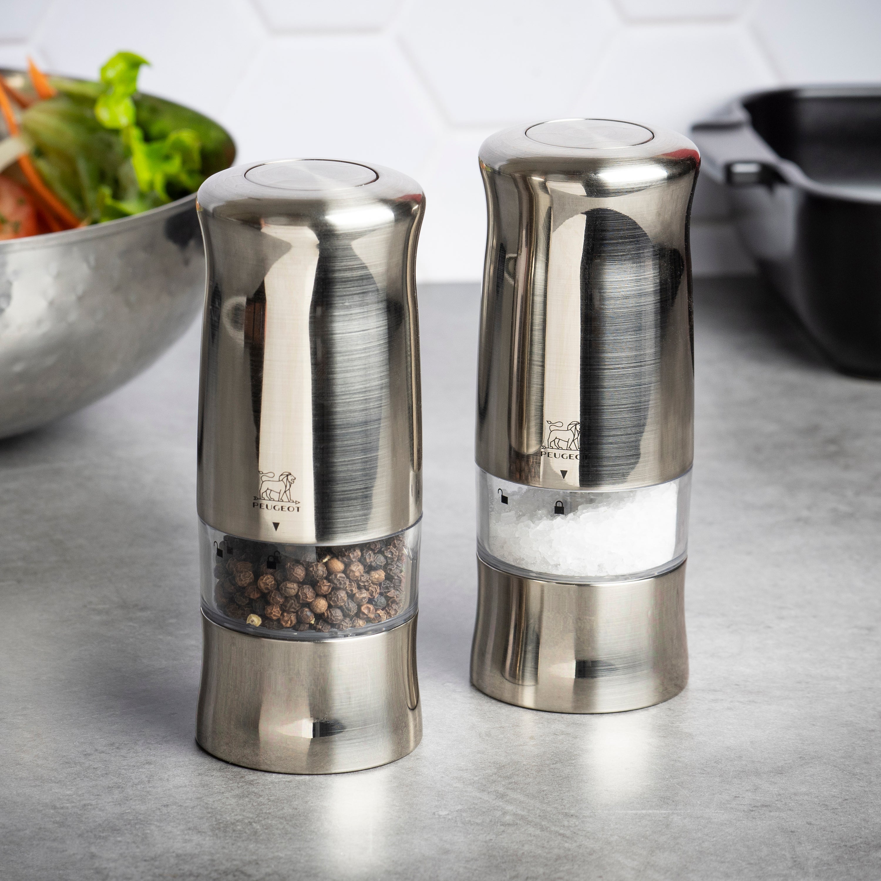 Peugeot Zeli electric salt and pepper mill set showcasing the light feature in use