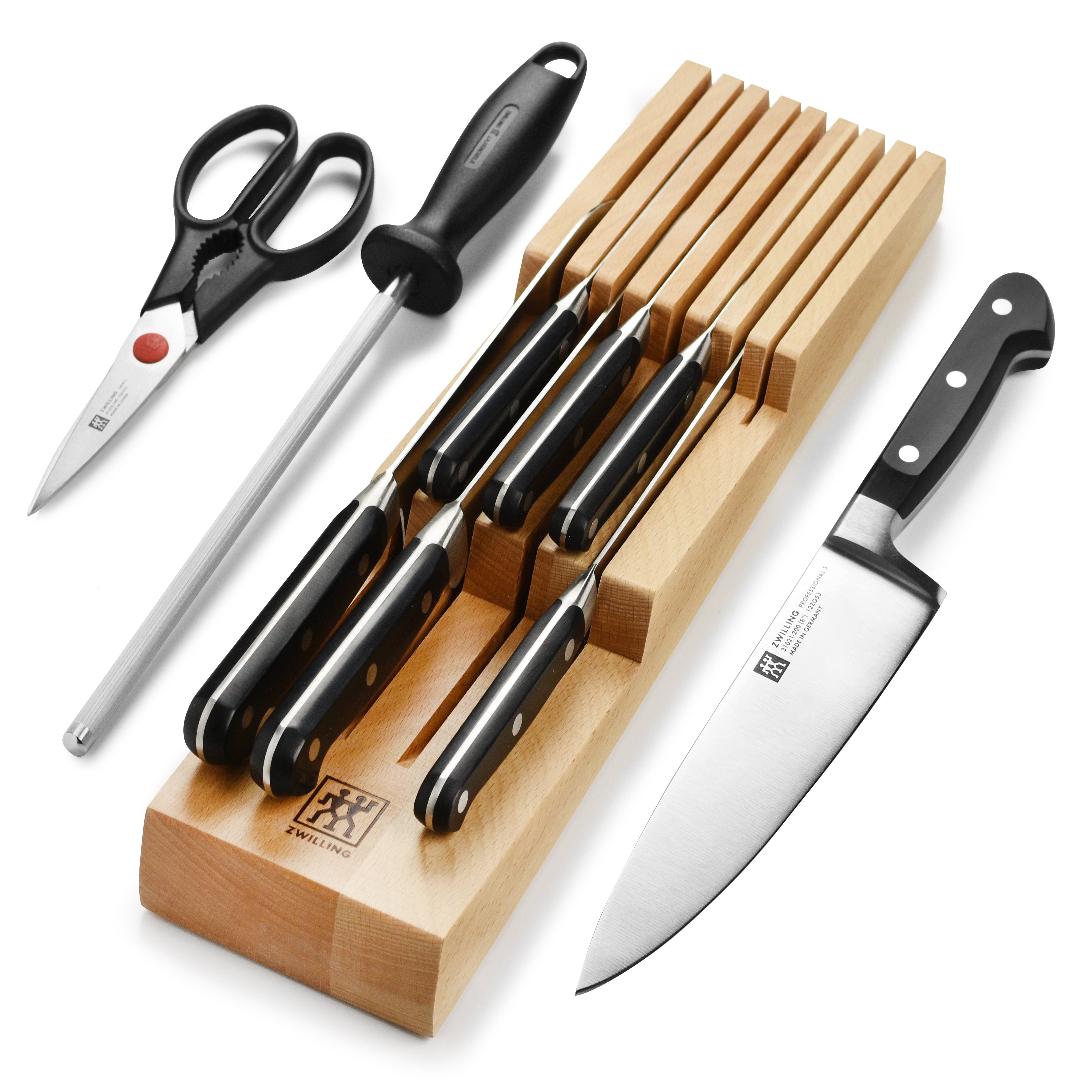Chef slicing vegetables using a sharp, durable Zwilling knife from the set