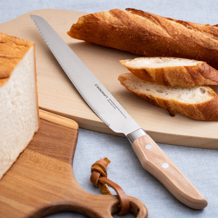 Close-up of Suncraft Seseragi bread knife showcasing serrated blade for left-handed users.