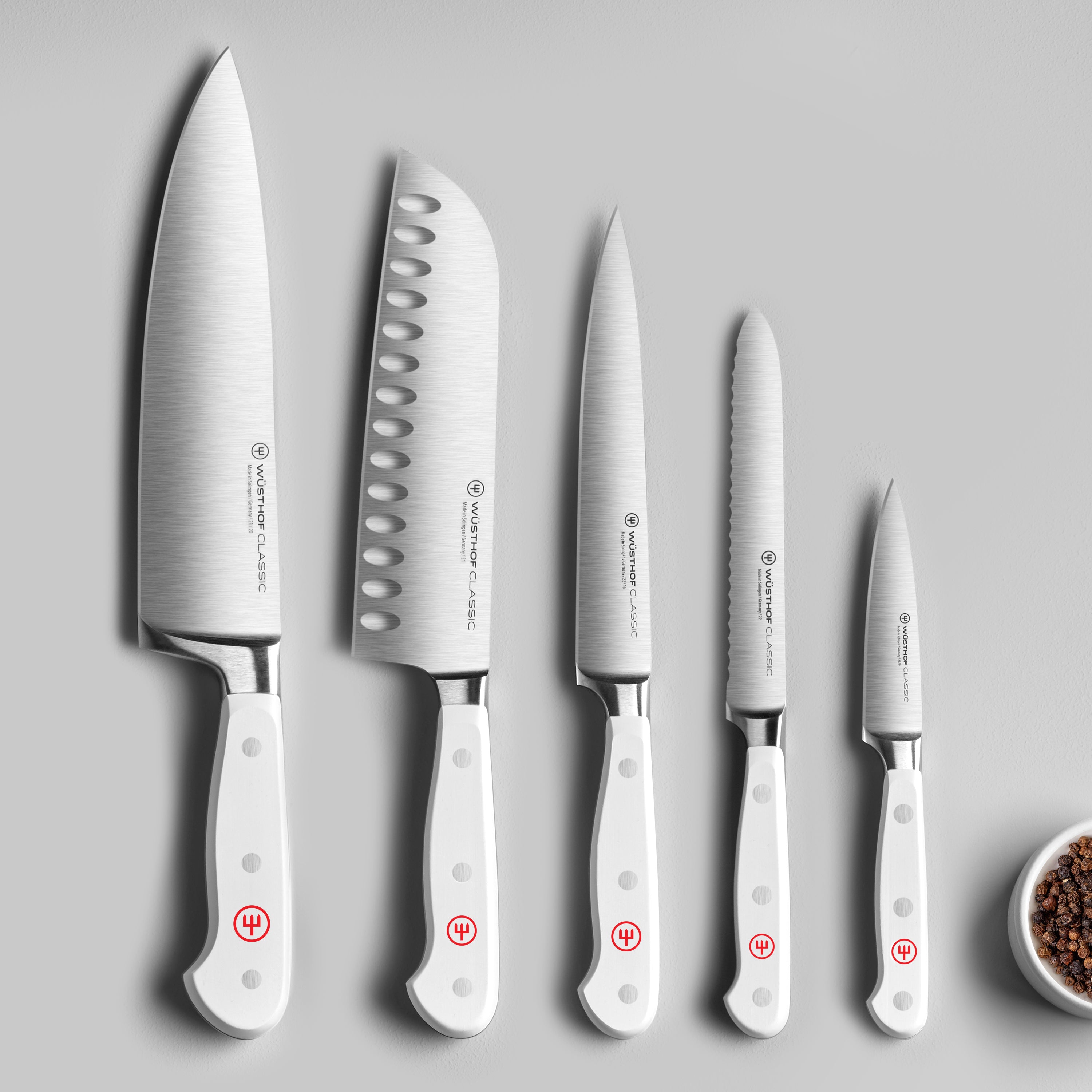 Home cook using the knife set to prepare vegetables in the kitchen
