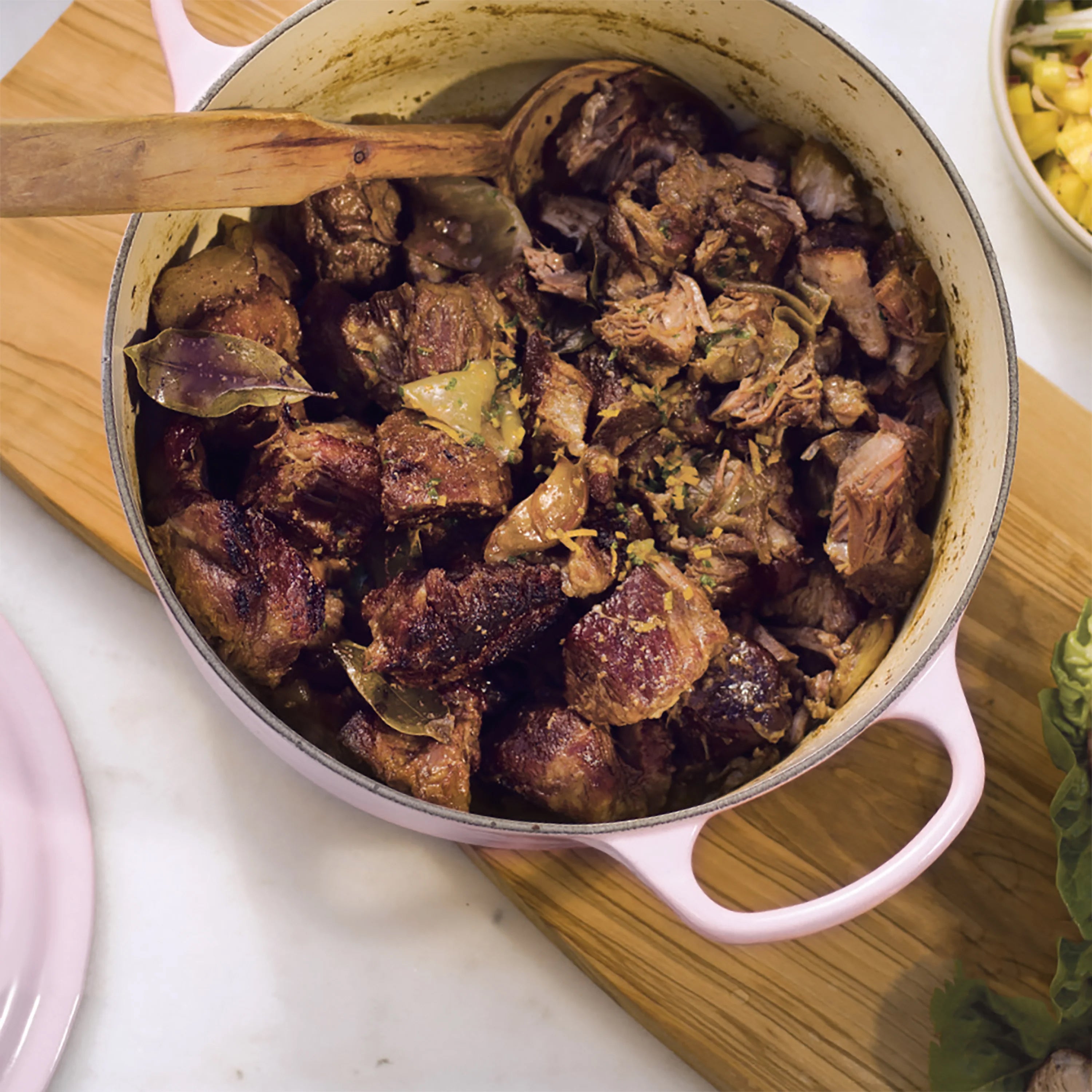 Open Le Creuset Dutch oven revealing a delicious stew, demonstrating its superior heat retention.