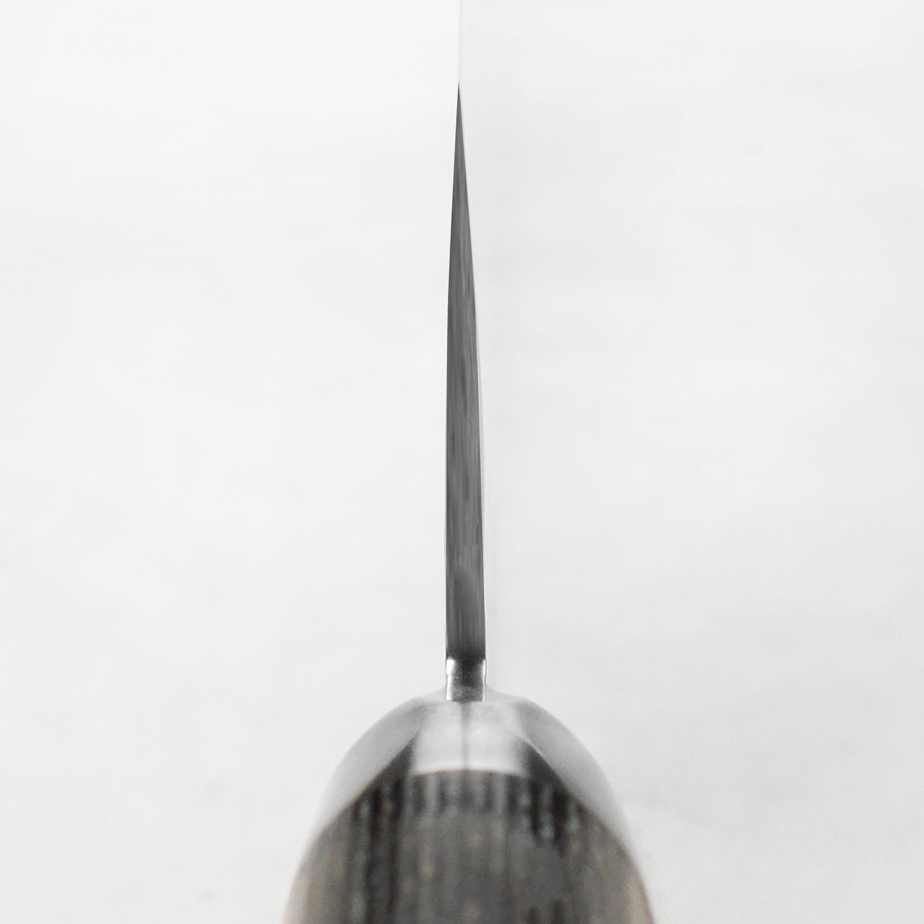 Close-up of the black beech pakkawood handle with a Samurai crest on the Nakiri knife.