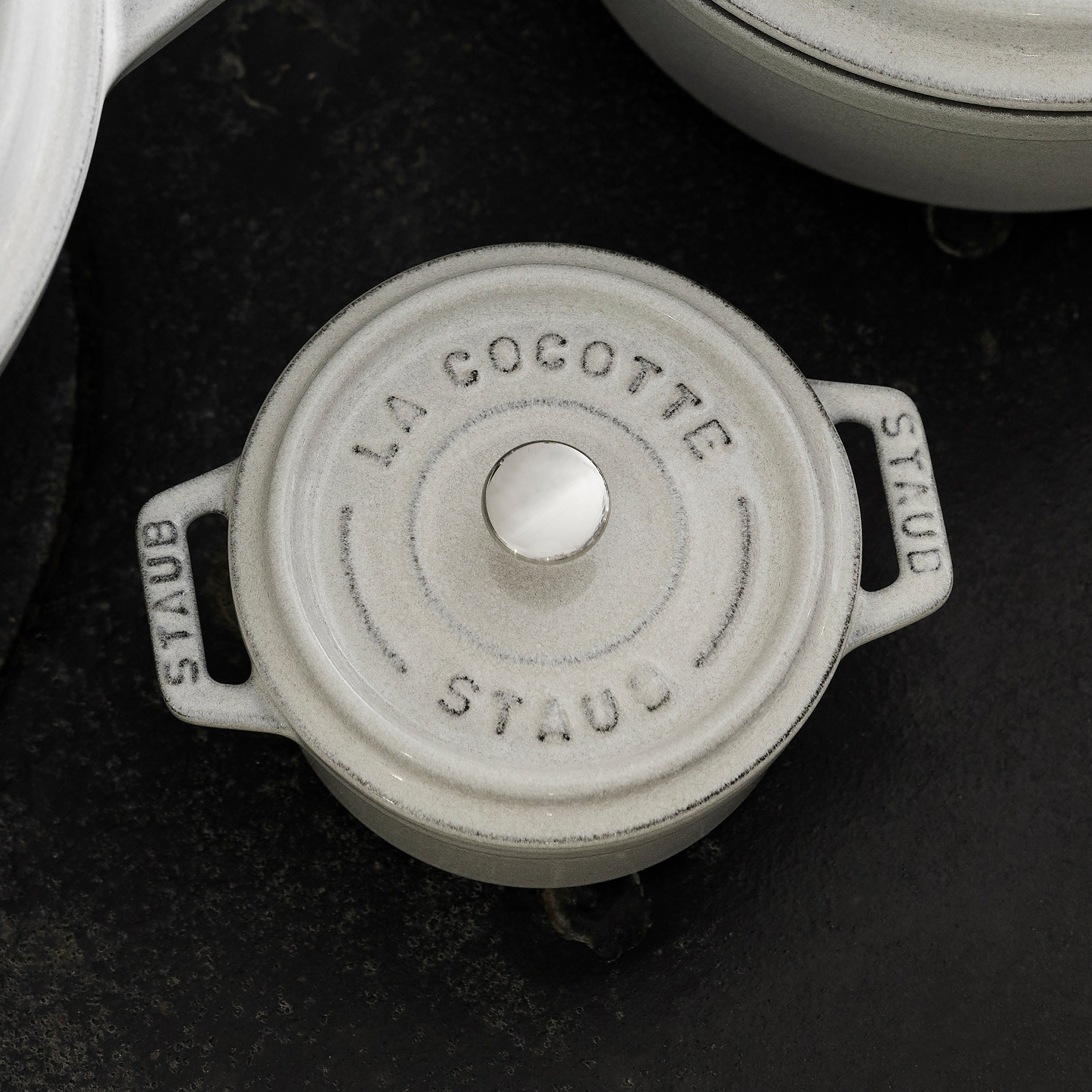The White Truffle Mini Round Enameled Dutch Oven beautifully presented on a dining table, ready for serving.