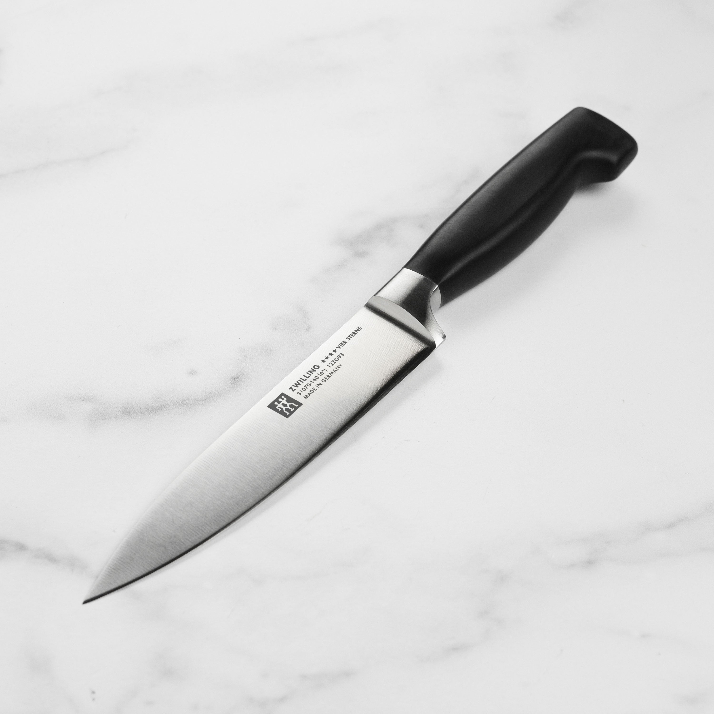 Close-up of Zwilling Four Star utility knife highlighting the sharp edge and sleek design