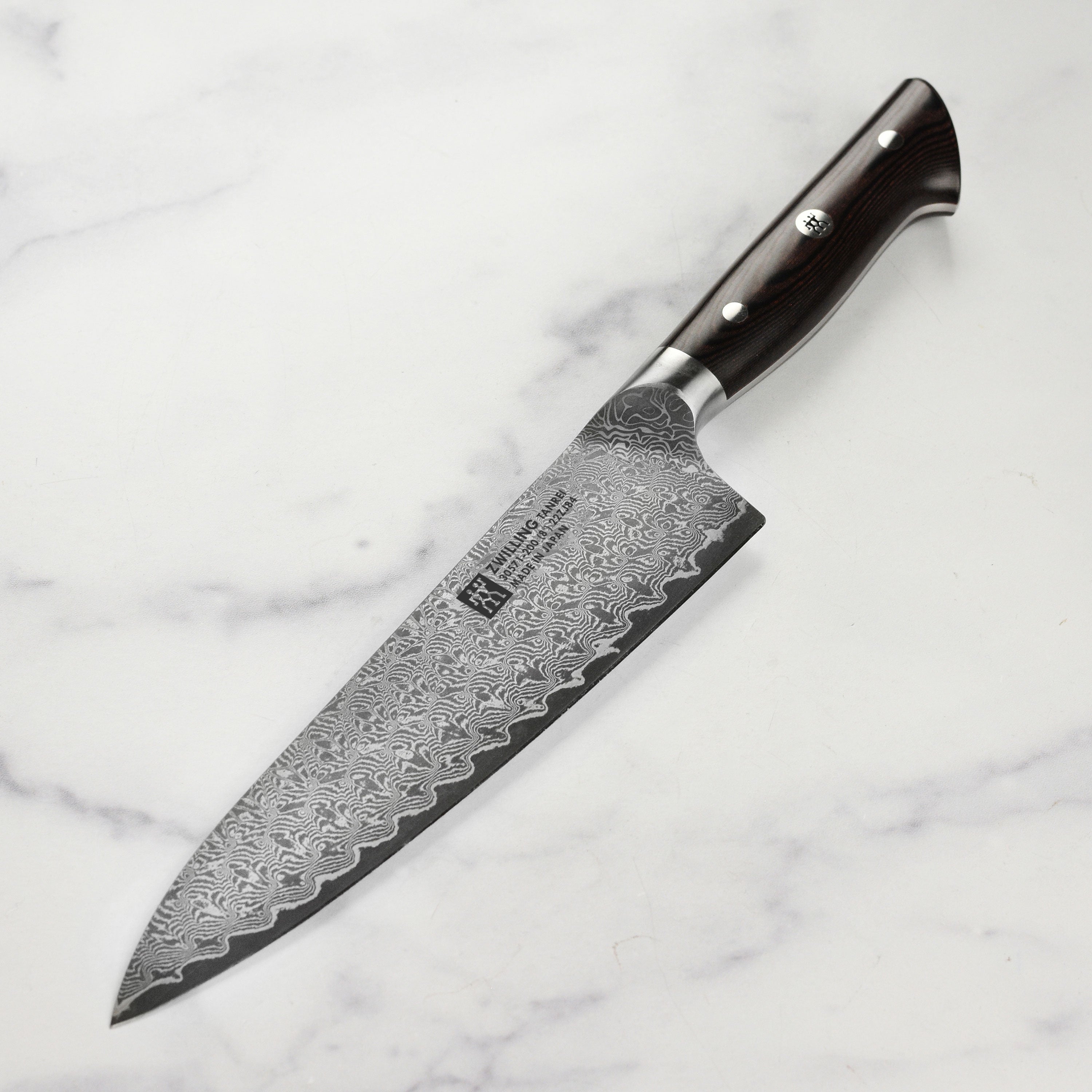 Front view of Zwilling Tanrei 8-inch Damascus chef's knife highlighting the layered blade