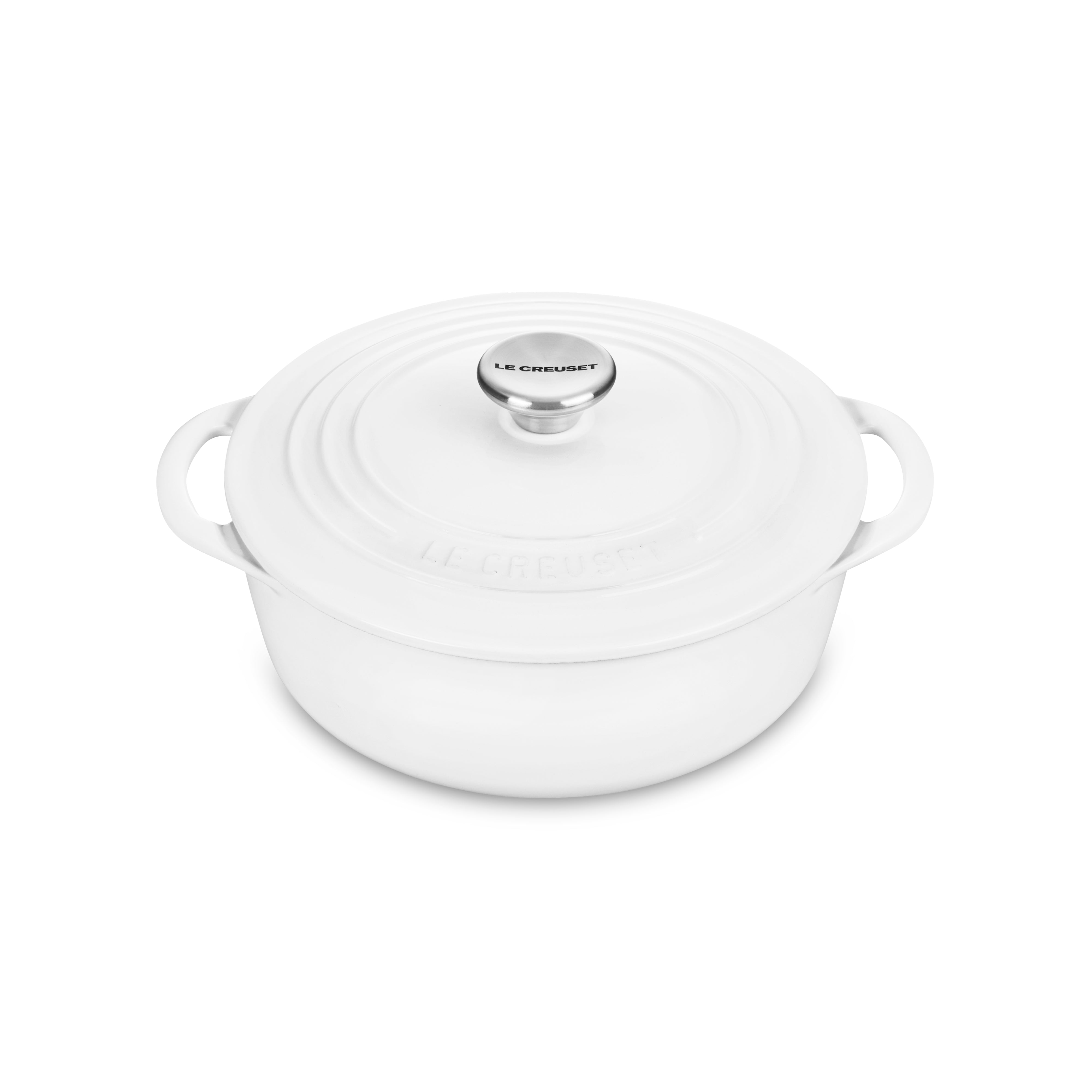 Close-up of Le Creuset shallow round Dutch oven, highlighting the ergonomic knobs and handles.