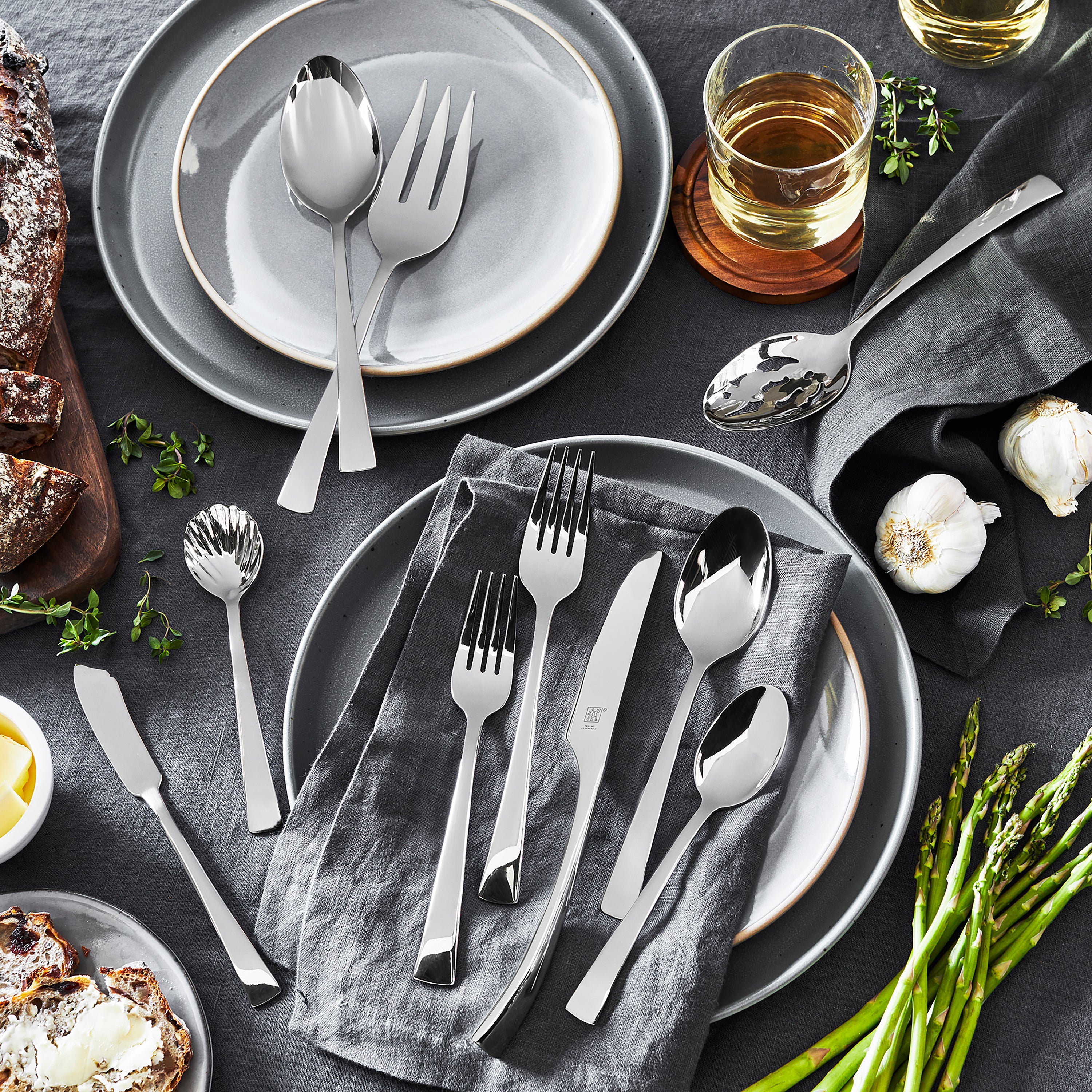 Set of stainless steel utensils arranged for a formal dinner setting