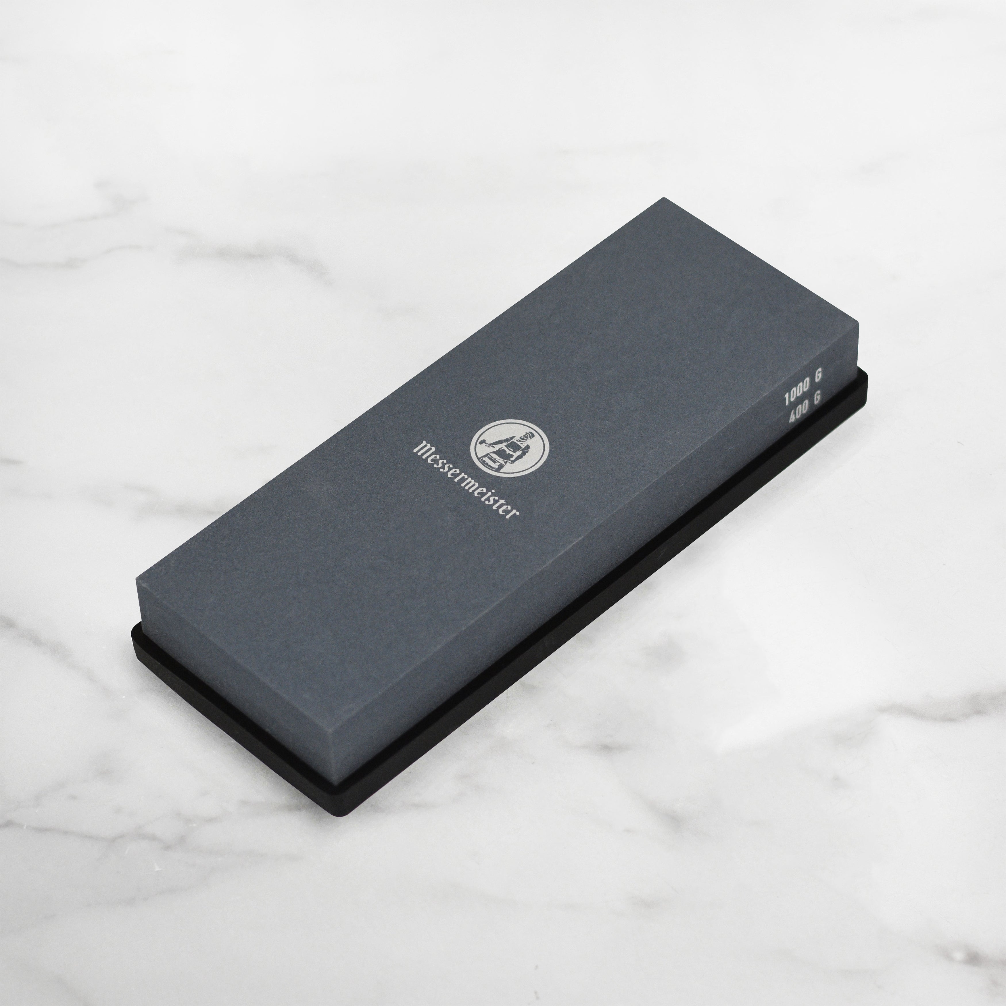 Close-up of Precision Edge sharpening stone in use, highlighting its 400 grit side for edge correction.