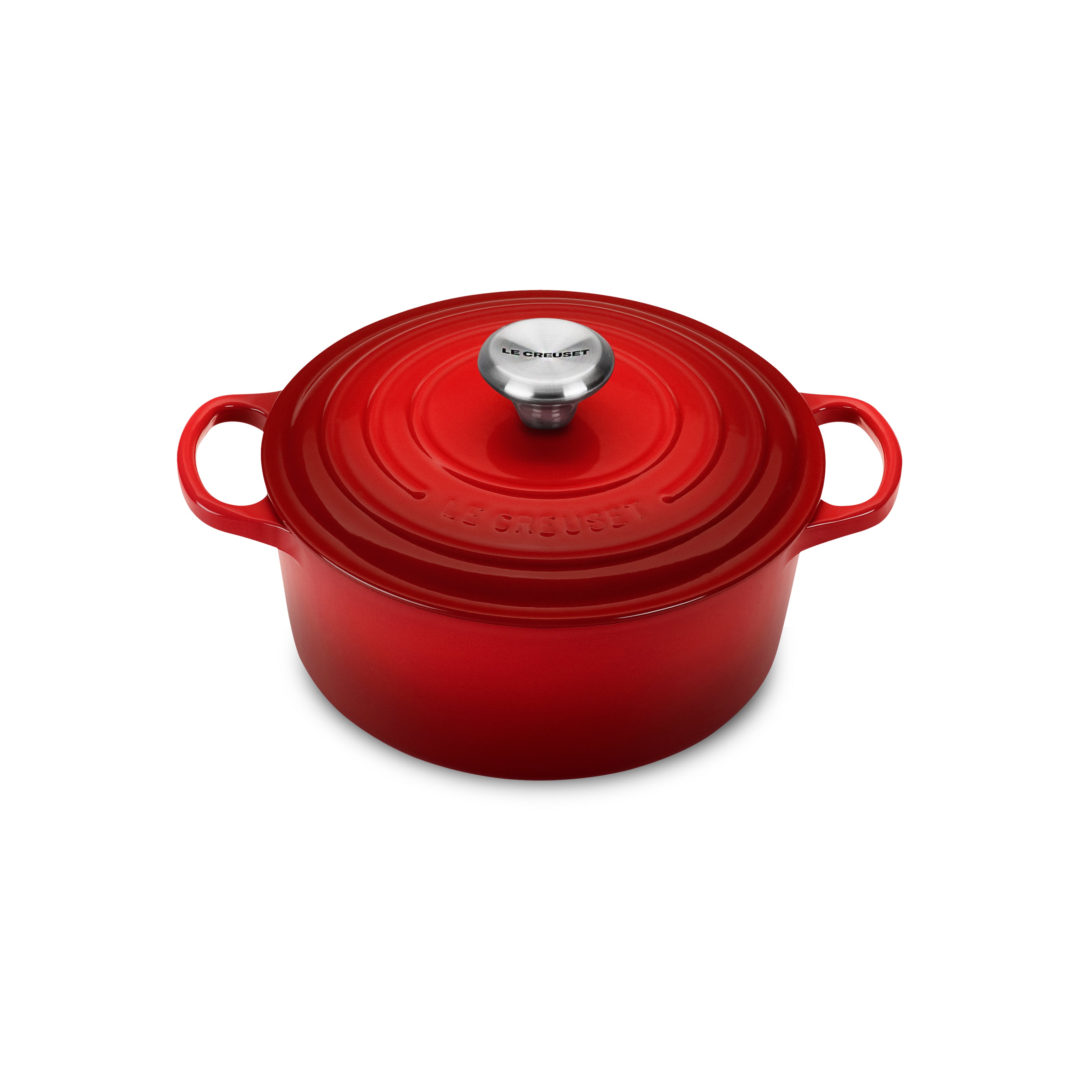 Le Creuset Cerise Dutch oven with lid on stove top, highlighting its vibrant color and enamel finish