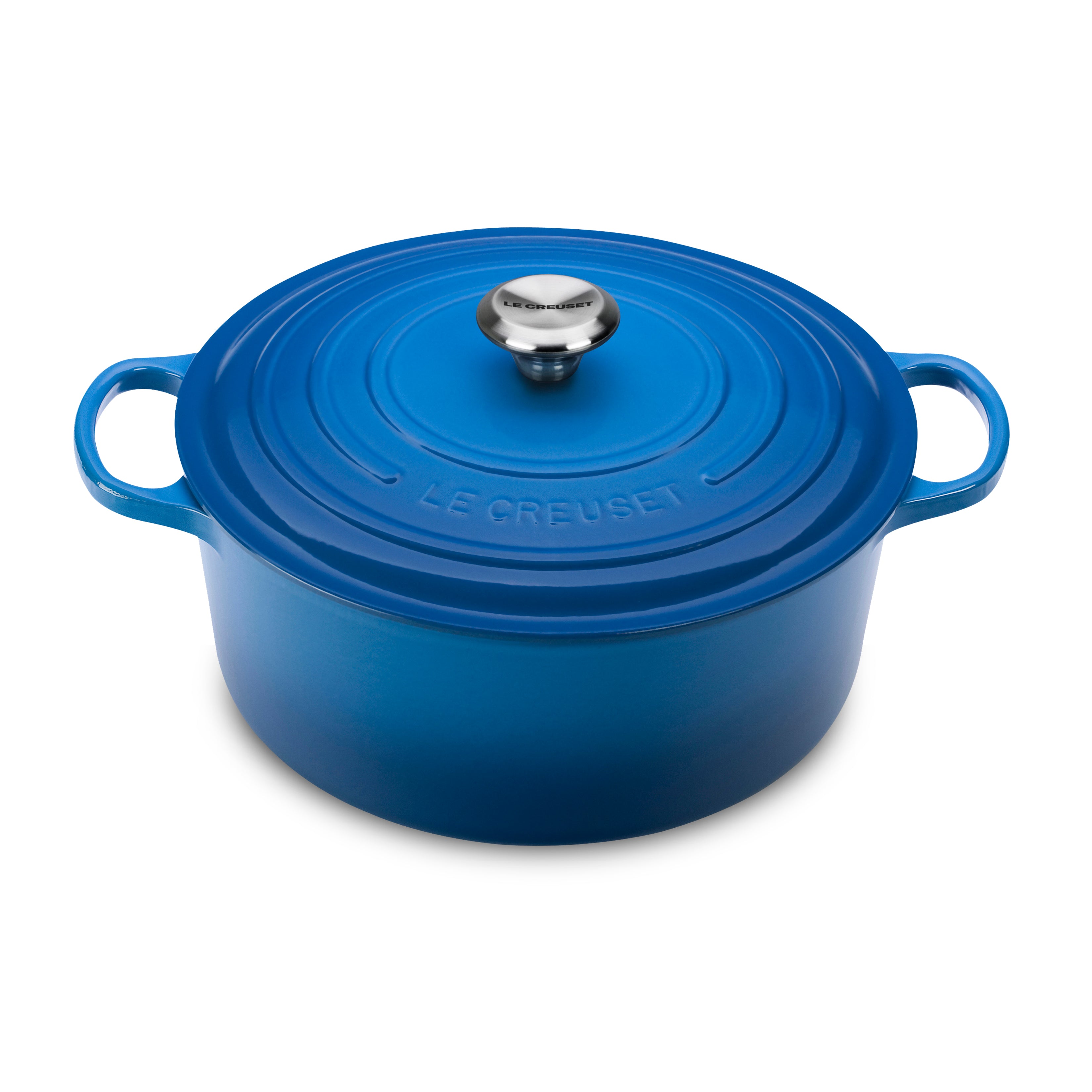 Le Creuset Marseille Dutch oven with lid on stove top, showing its enamel coating and ergonomic handles