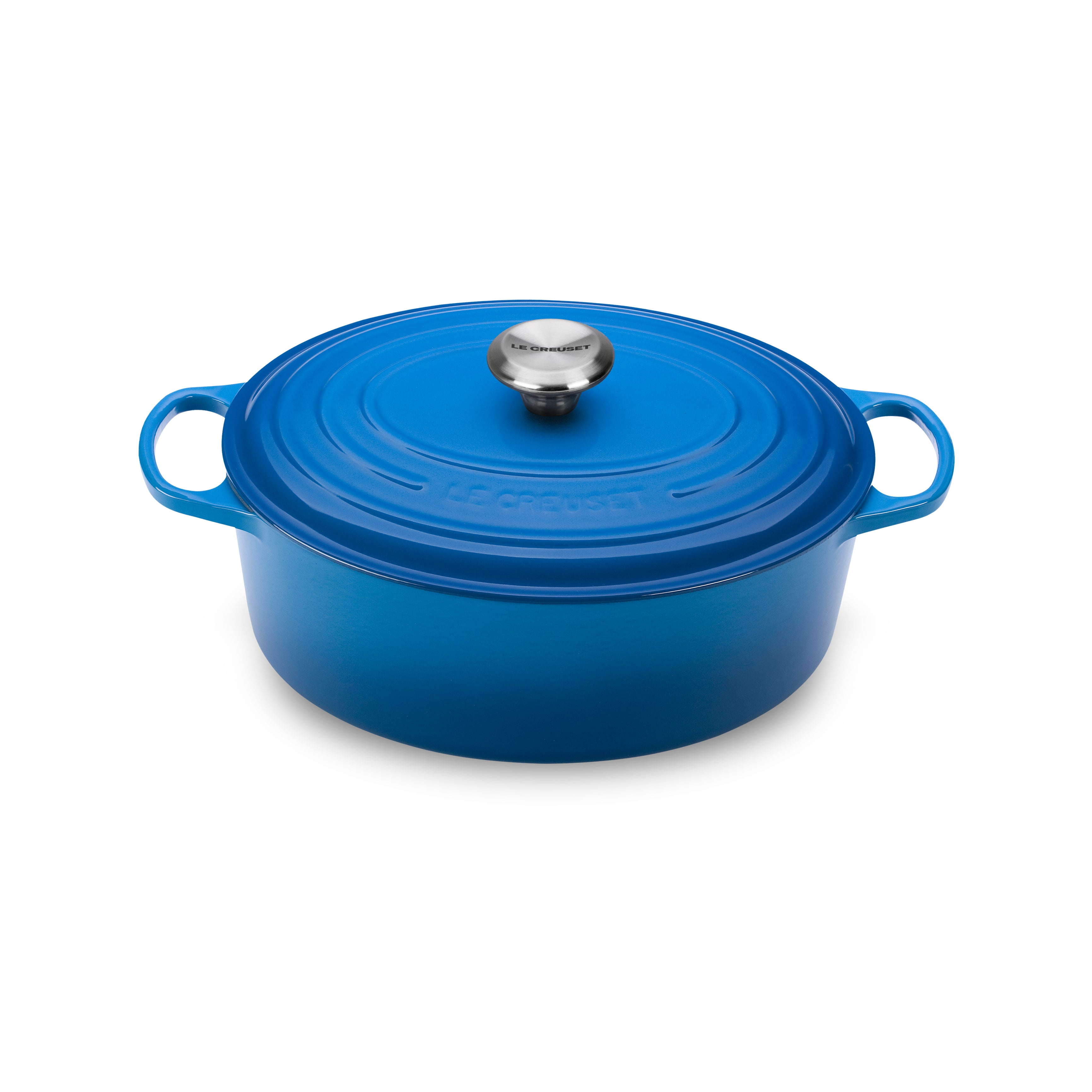 Overhead view of Le Creuset Dutch oven on a stovetop showcasing its wide-loop handles and tight-fitting lid