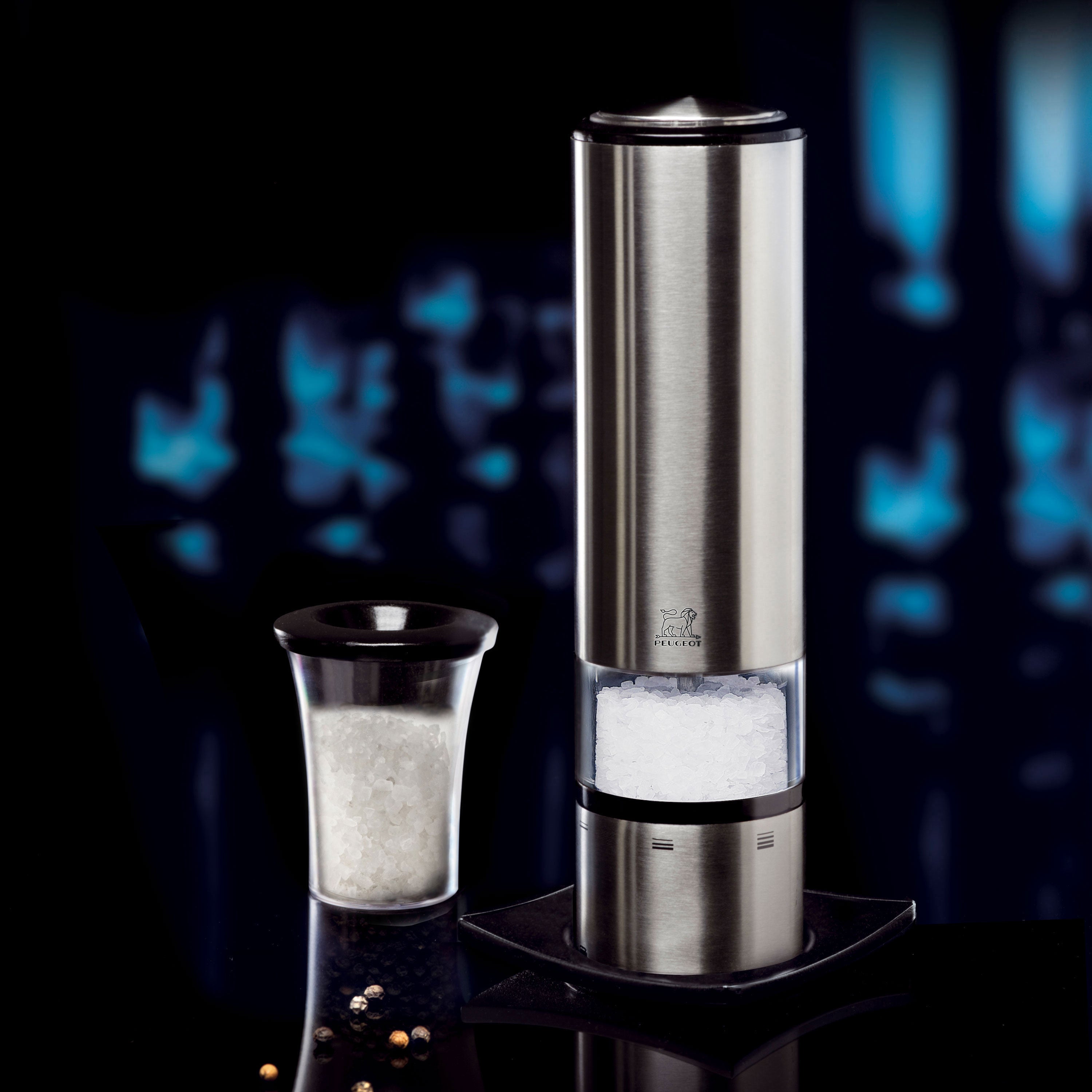 Elegant stainless steel electric salt mill with LED light in use