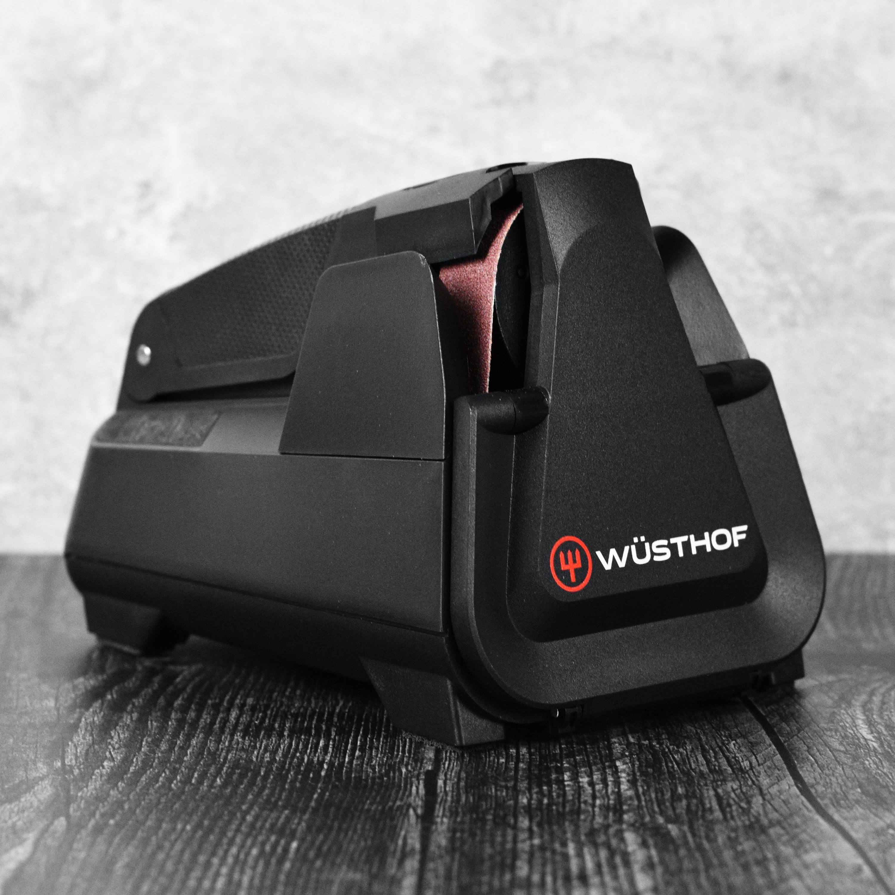 Wusthof Easy Edge Pro Electric Knife Sharpener in action, sharpening a chef's knife.