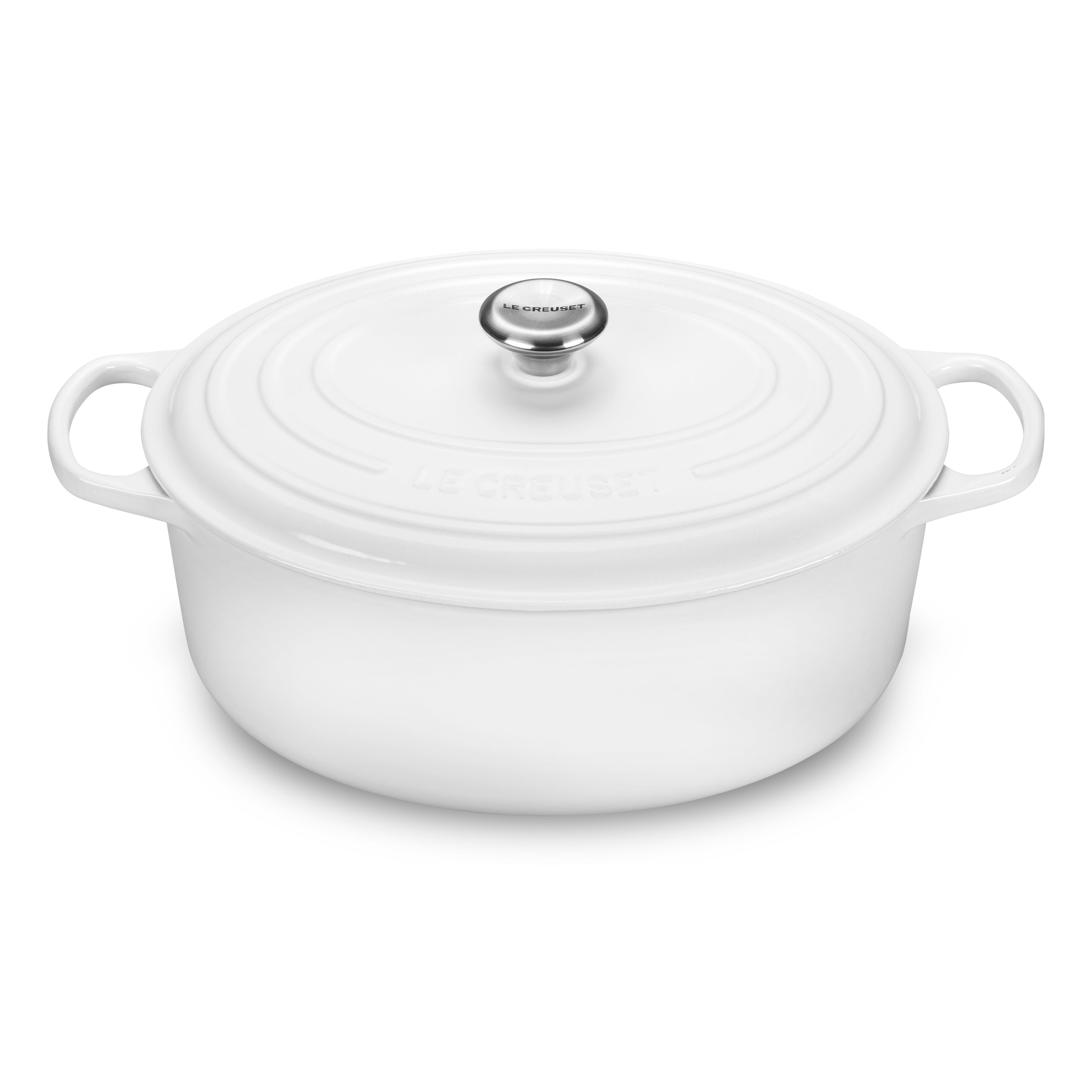 Le Creuset white oval Dutch oven close-up showing enameled surface and lid