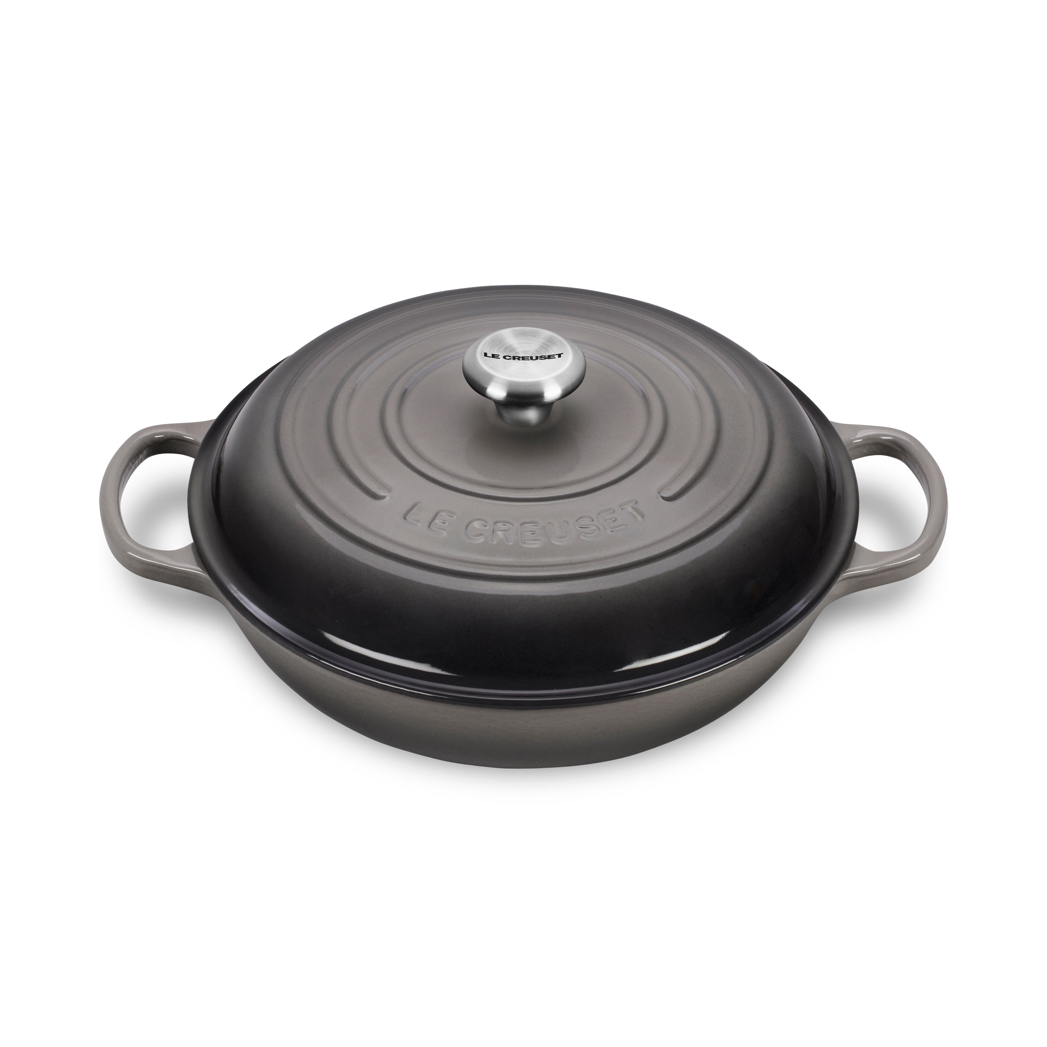 Le Creuset enameled cast iron braiser with lid on stovetop, showcasing heat distribution