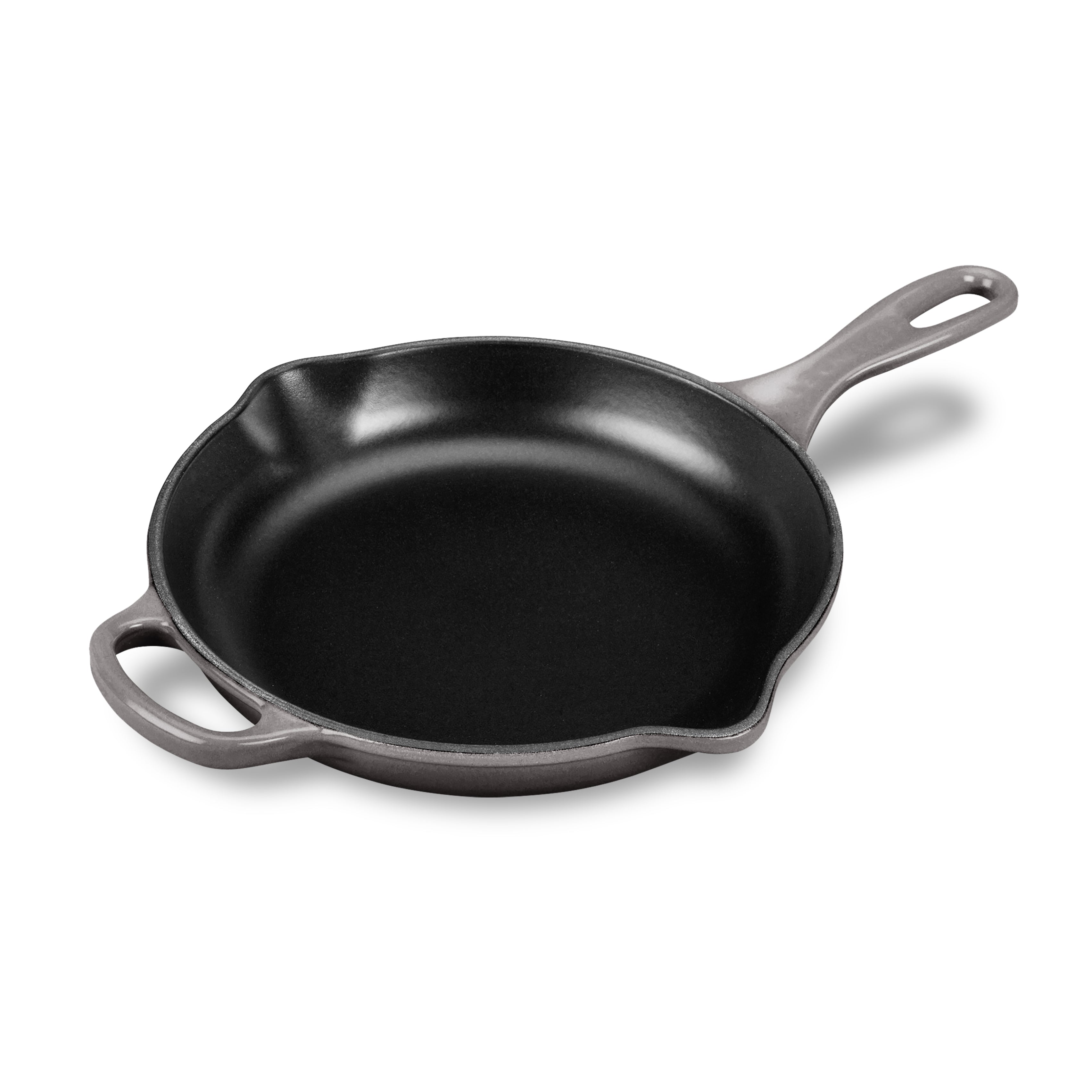 Overhead view of Le Creuset cast iron skillet showing its oyster enamel and dual handles